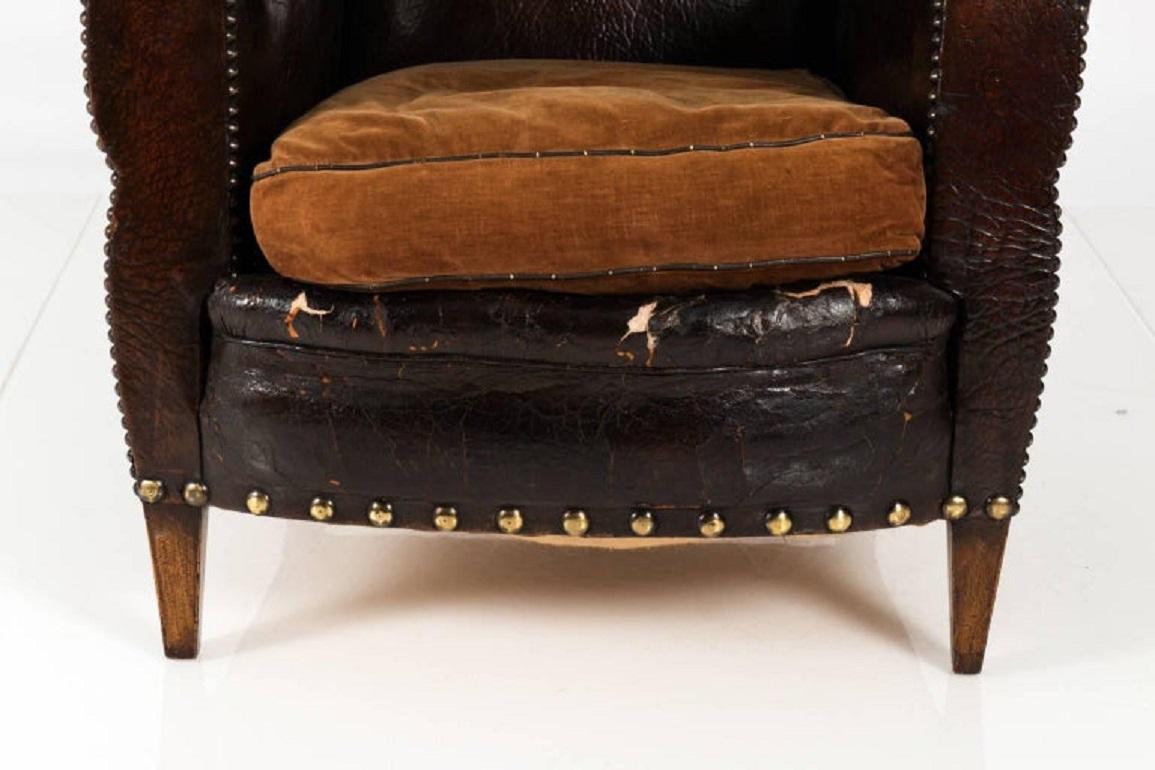 English leather club chair with velvet cushion and oversized nailhead trim, circa 1890.