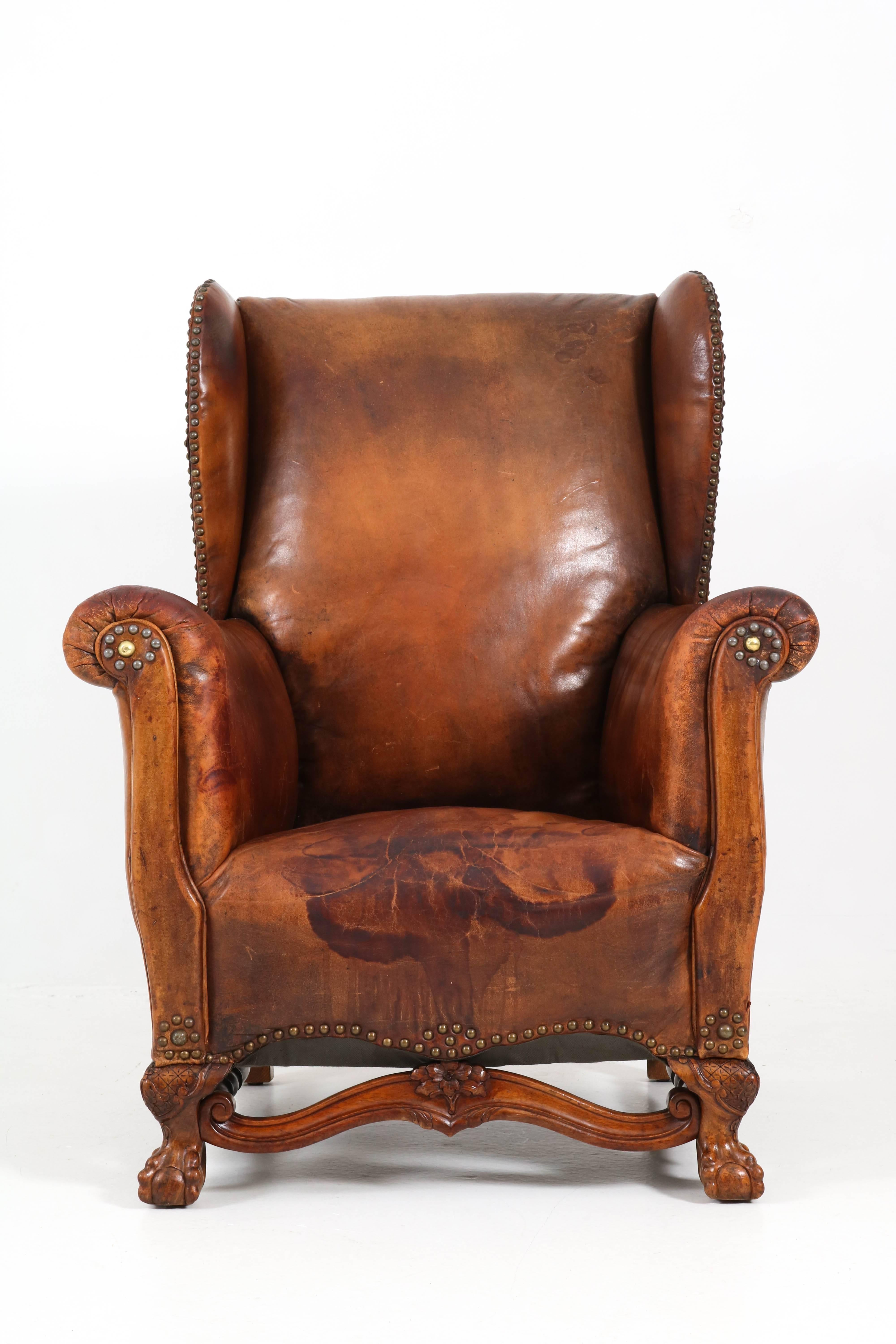 Stunning English wingback chair with wonderful patina.
Original leather upholstery on walnut Chippendale ball claw feet.
In good original condition with minor wear consistent with age and use.
   