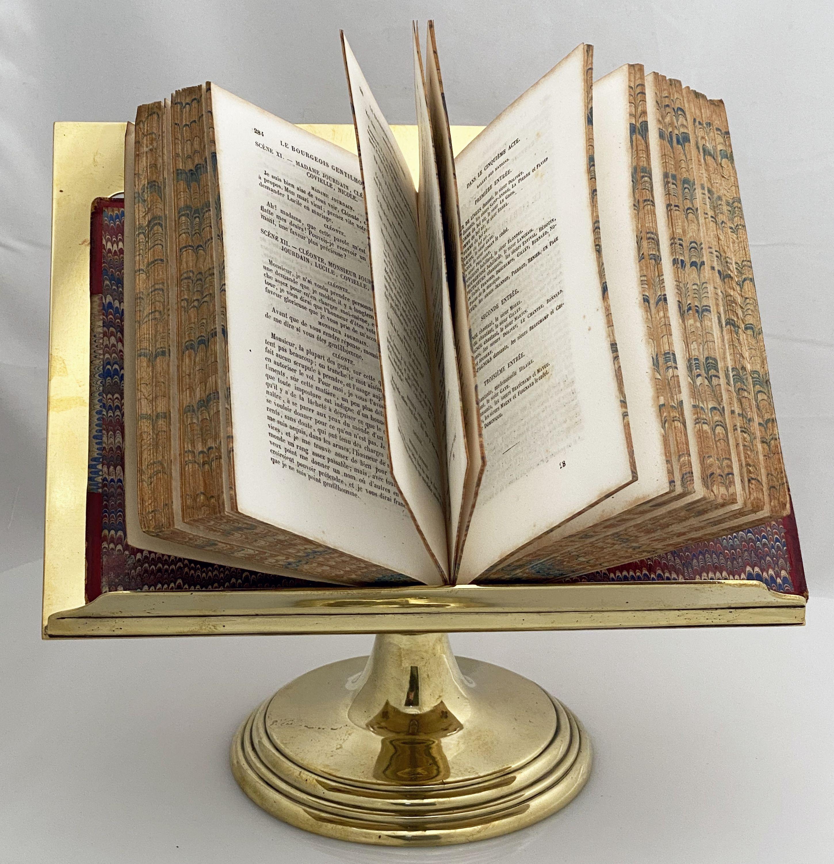 A fine English table top lectern, missal or book stand of brass, featuring a reading top with pierced quatrefoils at each corner. The revolving rectangular top attached to a weighted circular base.

Suitable for displaying various sized books - an