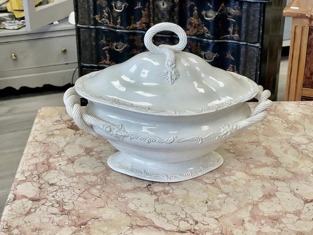 Lovely  Leeds Creamware Tureen and Cover, England, c. 1800.  Entwined double handles to an oval bowl with feather edge borders, 8.5 h. x  13” w.  9” d.

