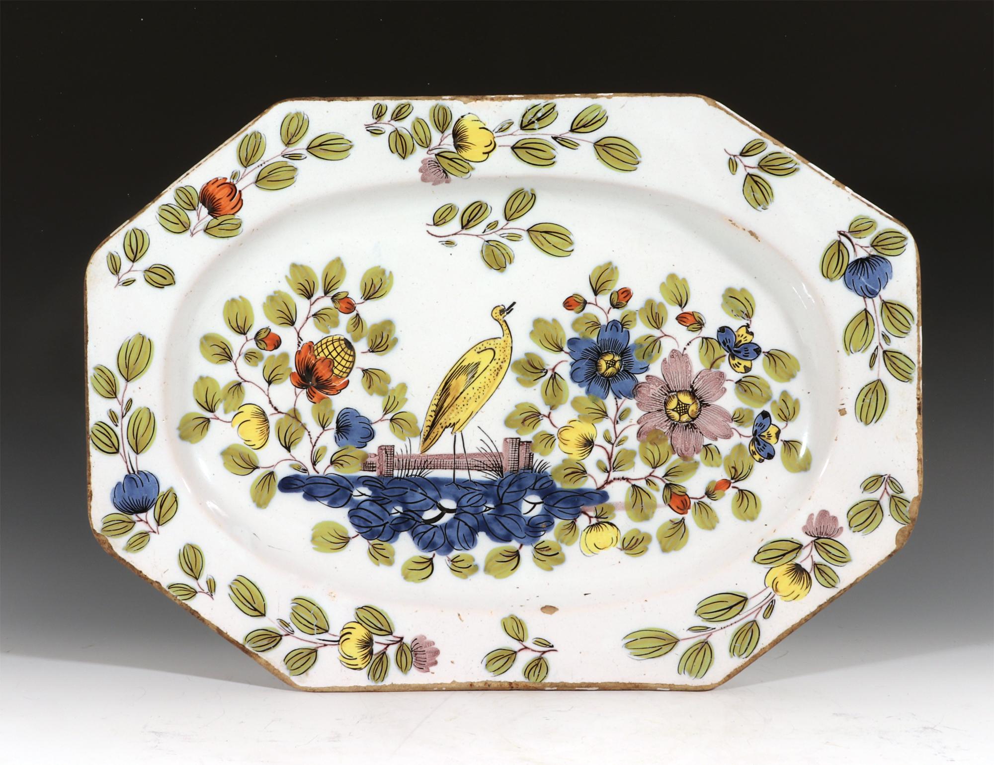 English Liverpool Delftware Fazackerly large dish with bird,
circa 1760

The Liverpool Delftware shaped large dish is painted with an unusual chinoiserie & Bird pattern in the Fazackerly colours of lemon yellow, orange, sage green, dark indigo