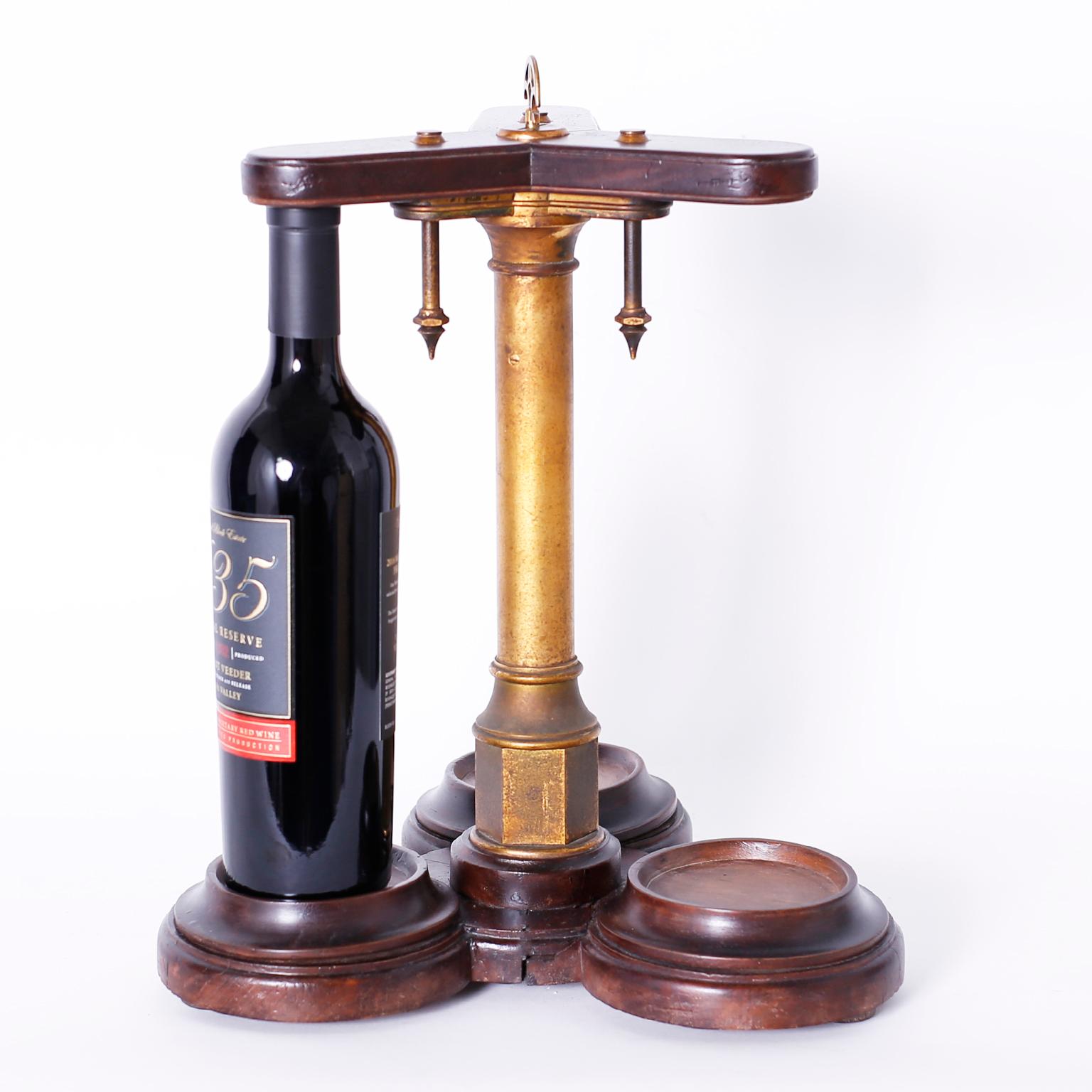 Antique English wine bottle rack crafted in mahogany and brass with an ingenious locking mechanism that moves with the turn of the key. Works with a 12.25