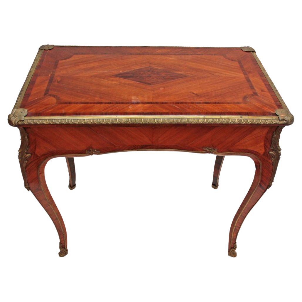 a Louis XIV-style side table of fruitwood with inlaid top, sides, and legs, ormolu trim around top, on legs and feet, single long drawer at one end, remarkable surviving Town & Emanuel paper label on drawer bottom, England, 1830-1849

LONDON
105 NEW