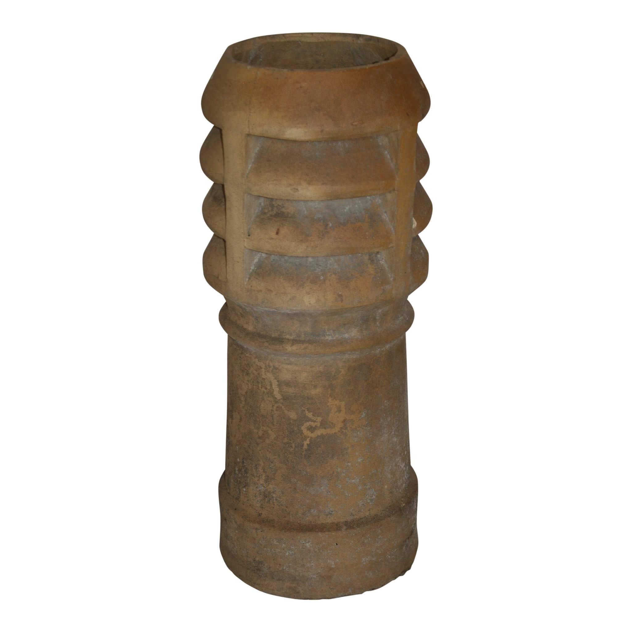 Originally used to help draw smoke up a chimney, this chimney pot with its louvered top makes a stunning architectural piece for garden or porch.