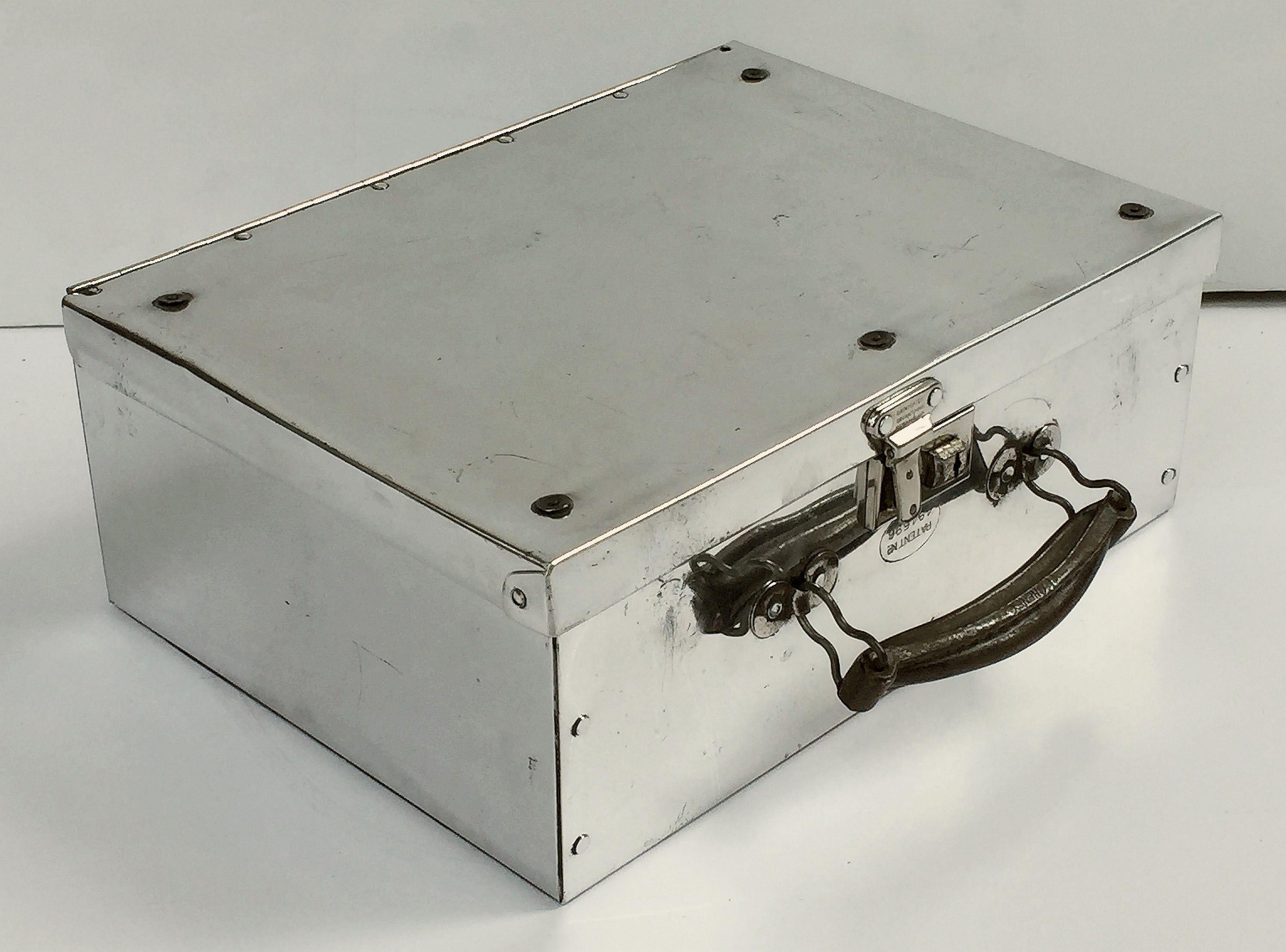 A fine English rectangular luggage case or traveler's suitcase of aluminum with original hardware and handle.


