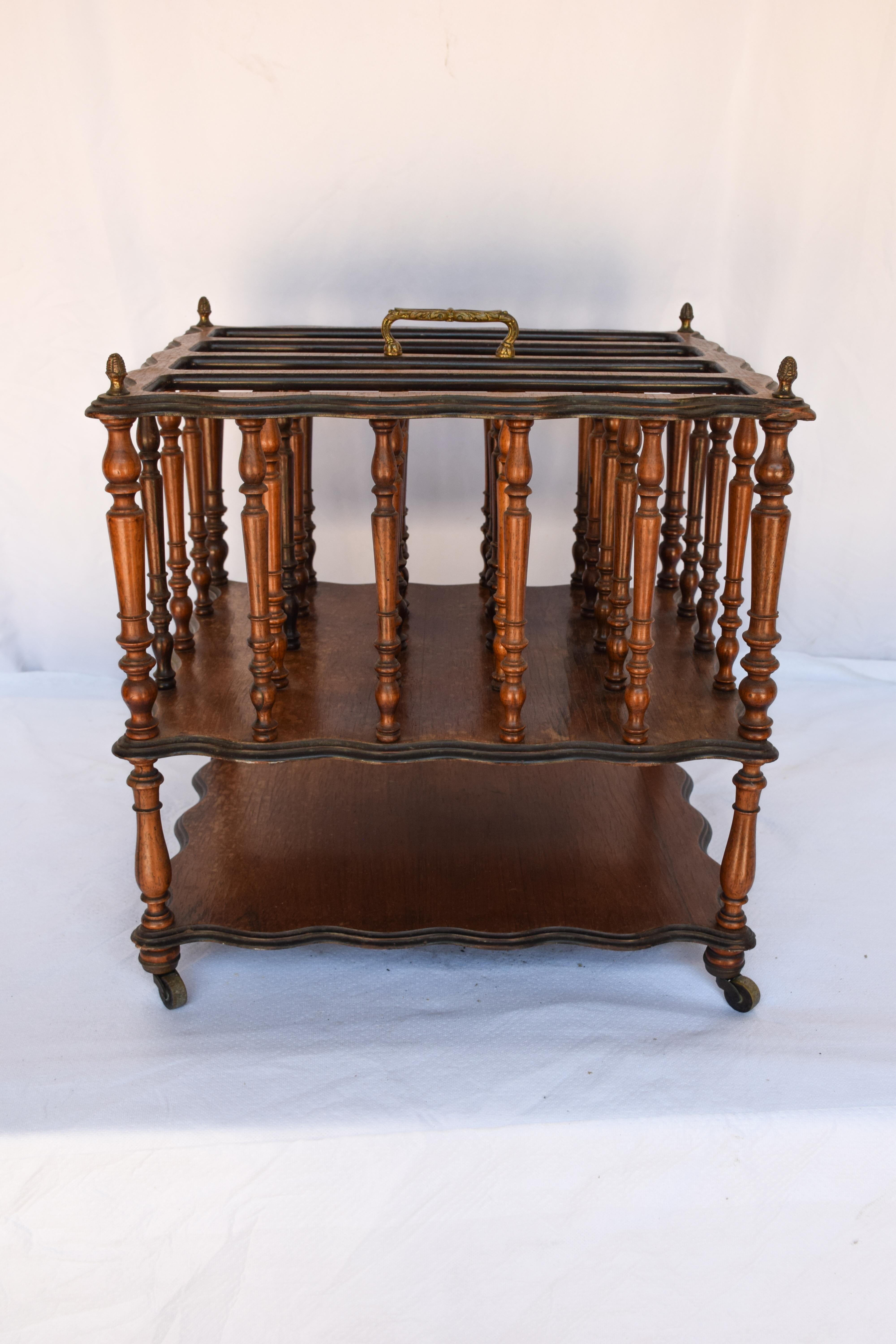 A good quality English Magazine Rack having four slatted divisions. Turned spindles with an additional shelf below. Accented with brass finials and a brass handle.

Measures: 14 1/2