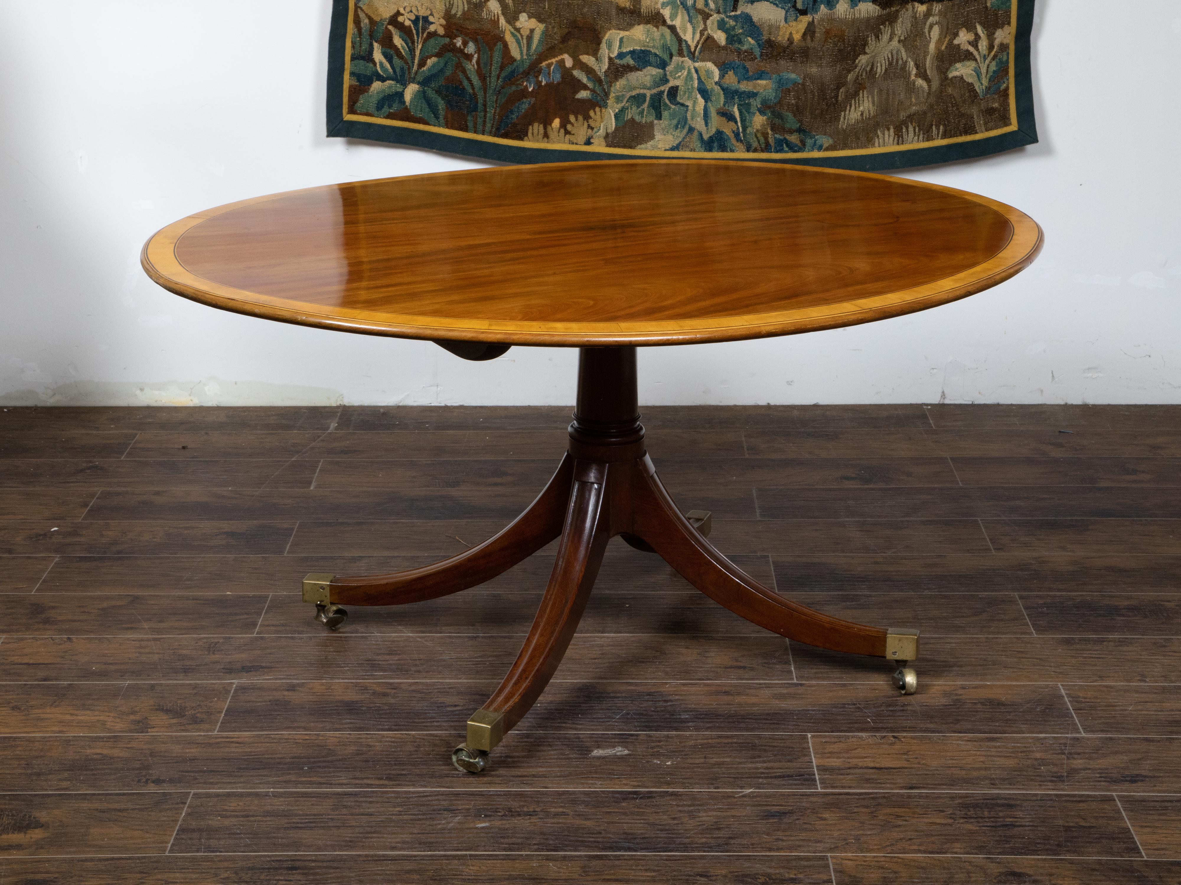 English Mahogany 1840s Oval Top Pedestal Table with Quadripod Base and Casters In Good Condition For Sale In Atlanta, GA