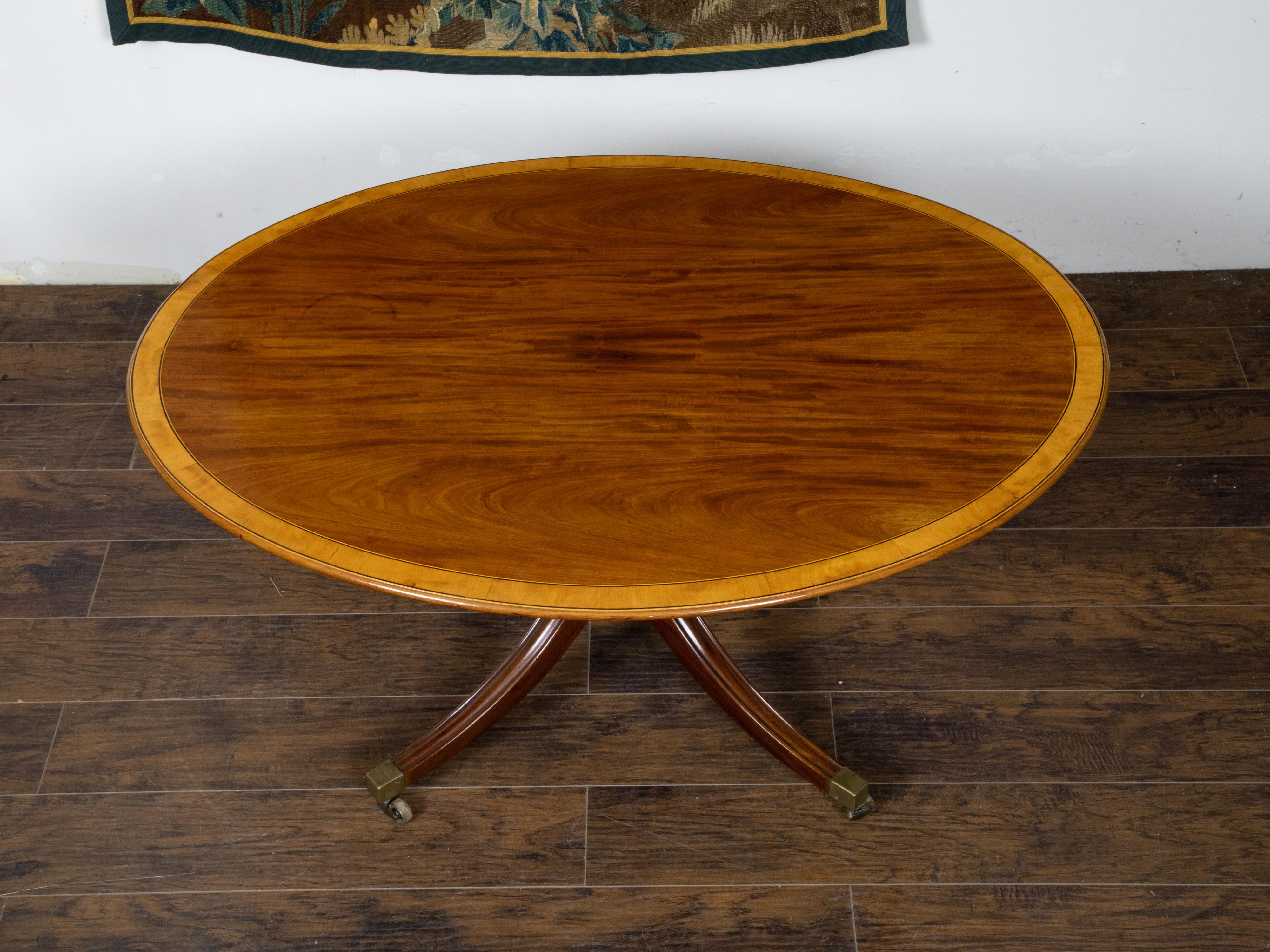 English Mahogany 1840s Oval Top Pedestal Table with Quadripod Base and Casters For Sale 3