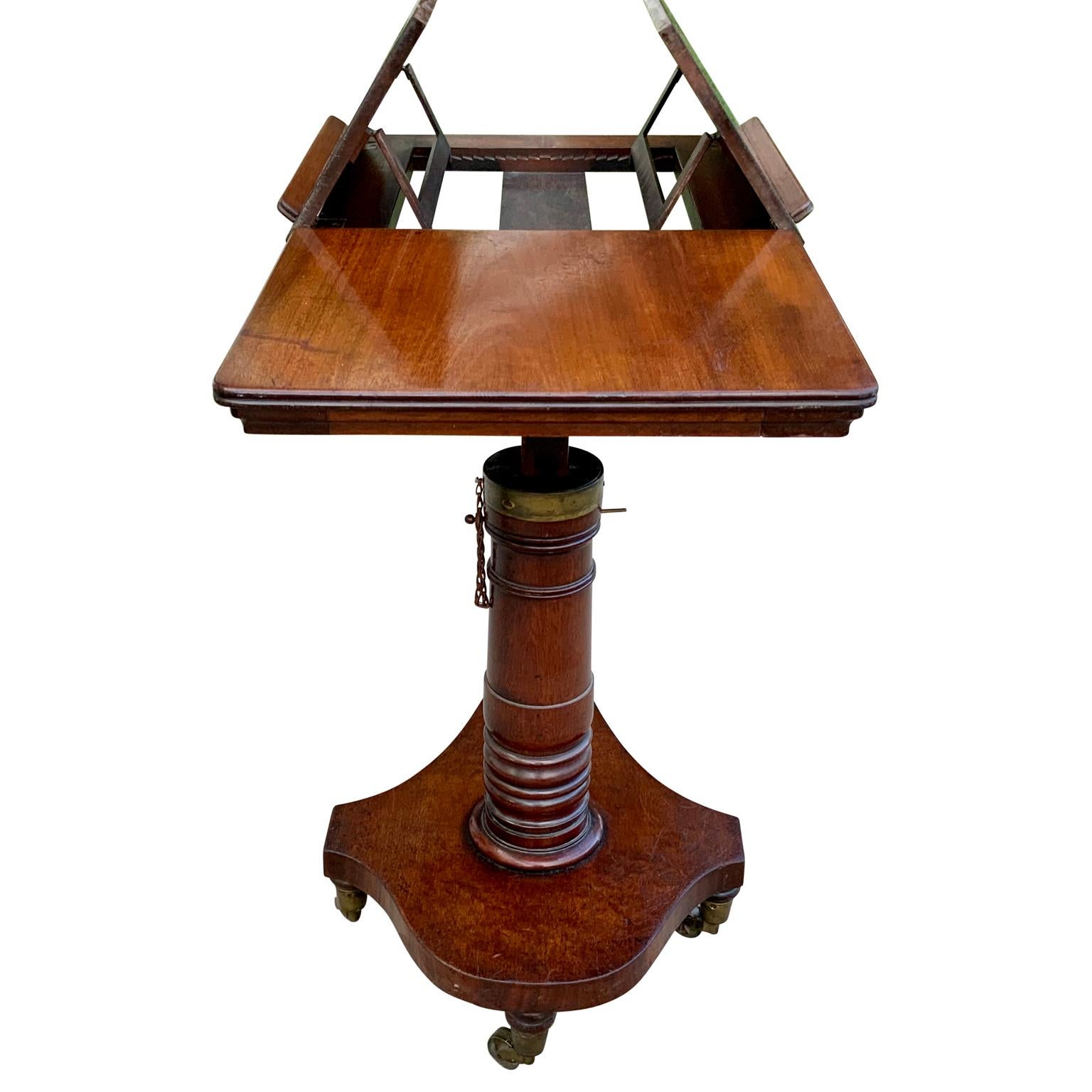 Double reading or musical table stand with adjustable height in mahogany, England 

Stand features a finely turned pedestal fully adjustable in height that supports a reading surface with opposing adjustable fold up slopes. With removable book