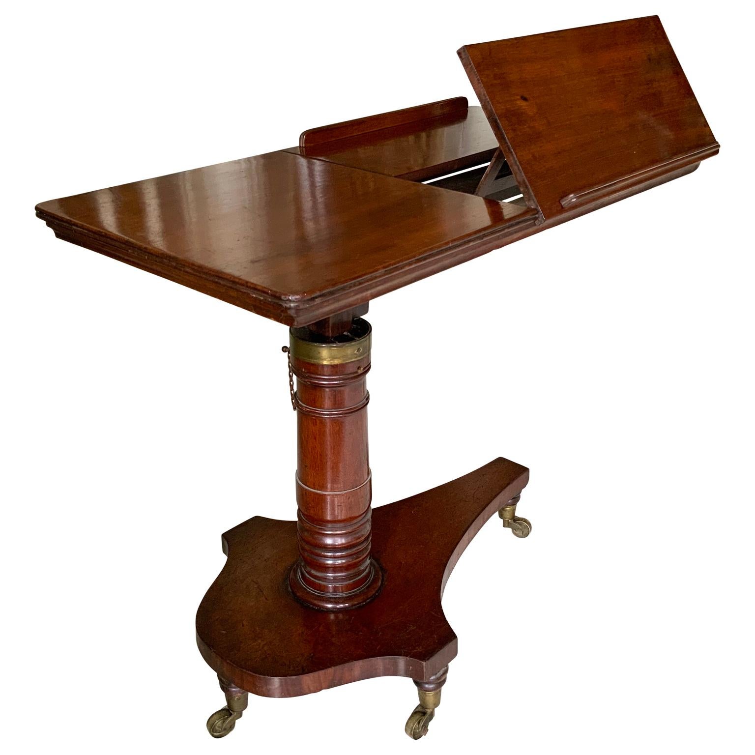 Double reading or musical table stand with adjustable height in mahogany, England 

Stand features a finely turned pedestal fully adjustable in height that supports a reading surface with opposing adjustable fold up slopes. With removable book