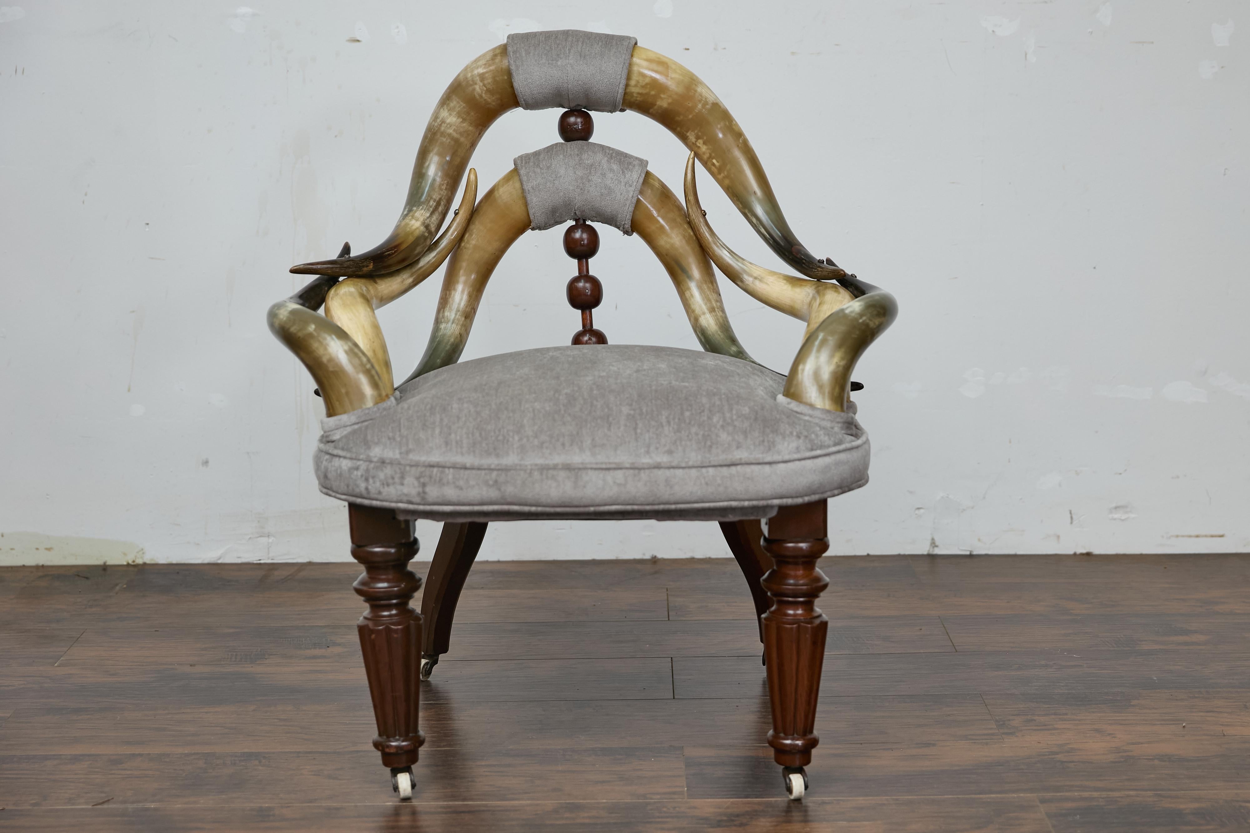 This striking English Victorian mahogany chair seamlessly marries rustic and refined elements, making it a true conversation starter. Crafted from polished horn arms that sweep gracefully around the back, the chair’s form captures a unique spirit of