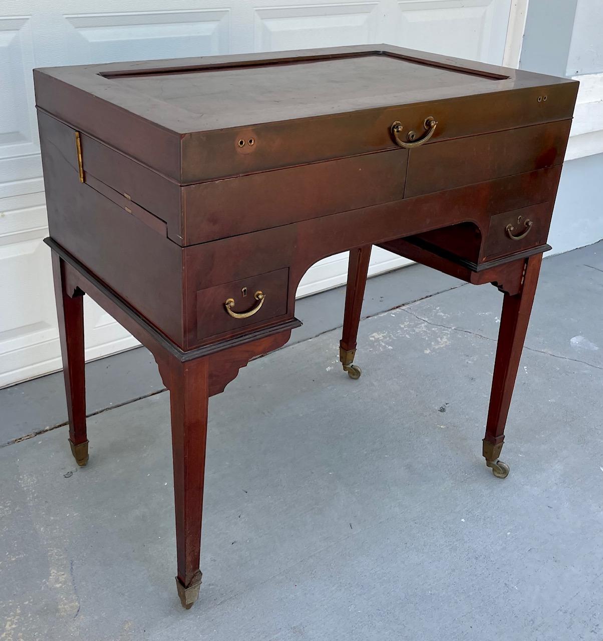 English Mahogany Beau Brummell Gentleman dressing desk. Aristocratic Pedigree. 

Outstanding example of a rare mechanical piece of furniture of museum quality. The luxurious polished Mahogany desk is raised on four square tapered legs on brass