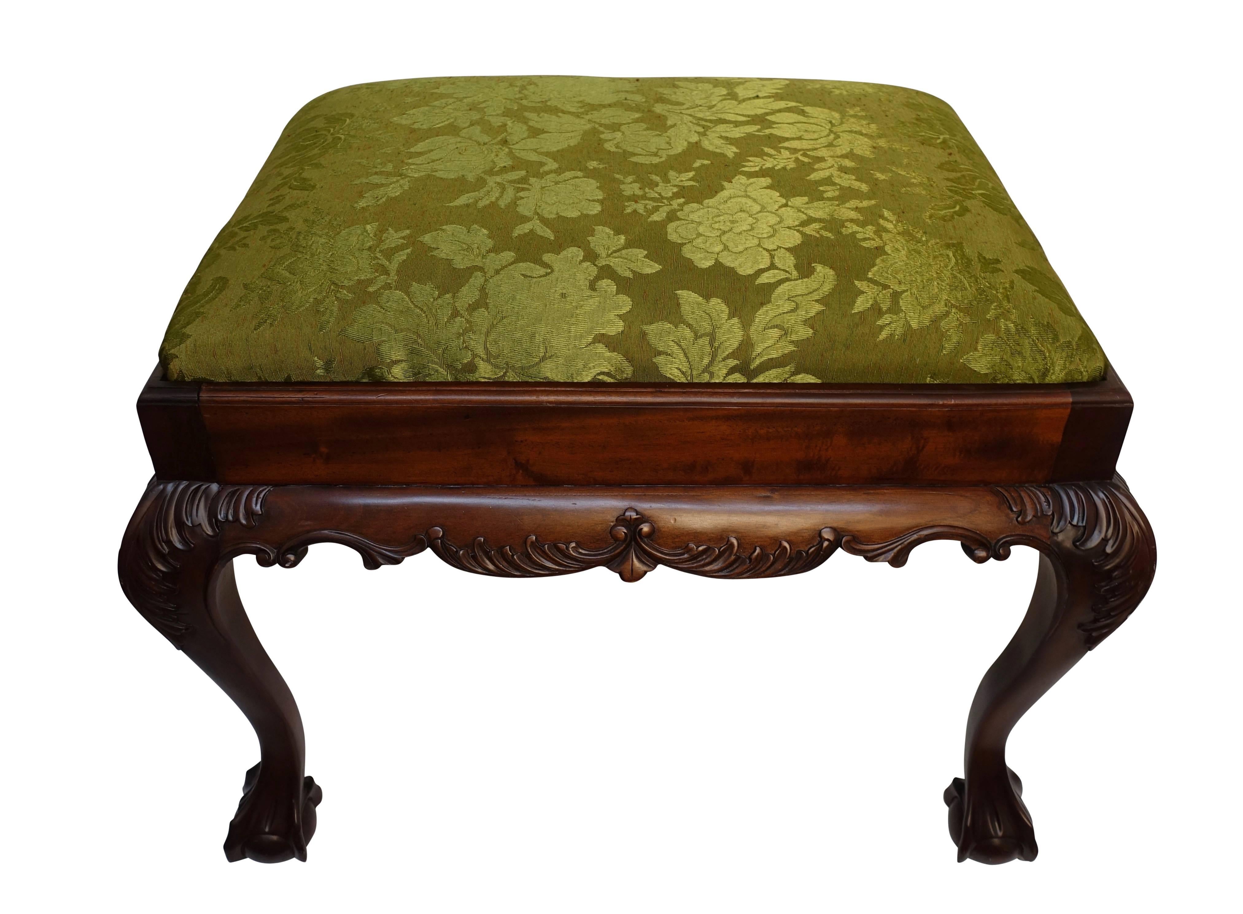 Chippendale style mahogany bench or stool with claw and ball feet, and having carved acanthus leaf carvings on the knees, England, first half of the 20th century.