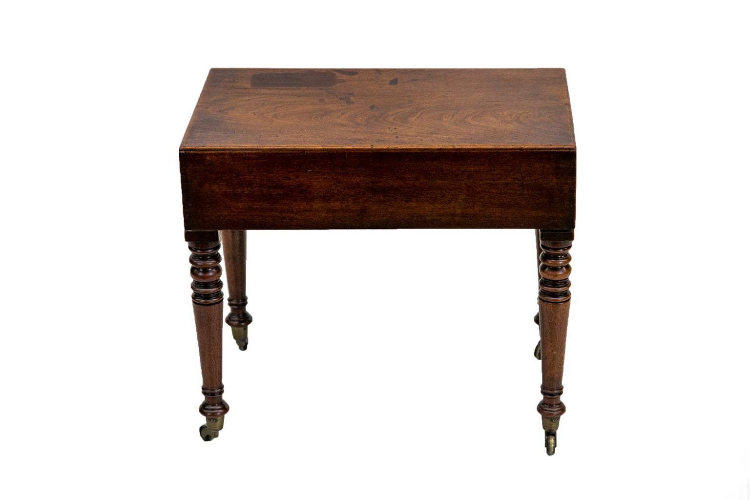 This English mahogany bidet table has a lift-off top that exposes the original Staffordshire earthenware liner, which is not cracked but has a three- by- one inch piece missing from the rim. The liner is removable. The top has dovetailed