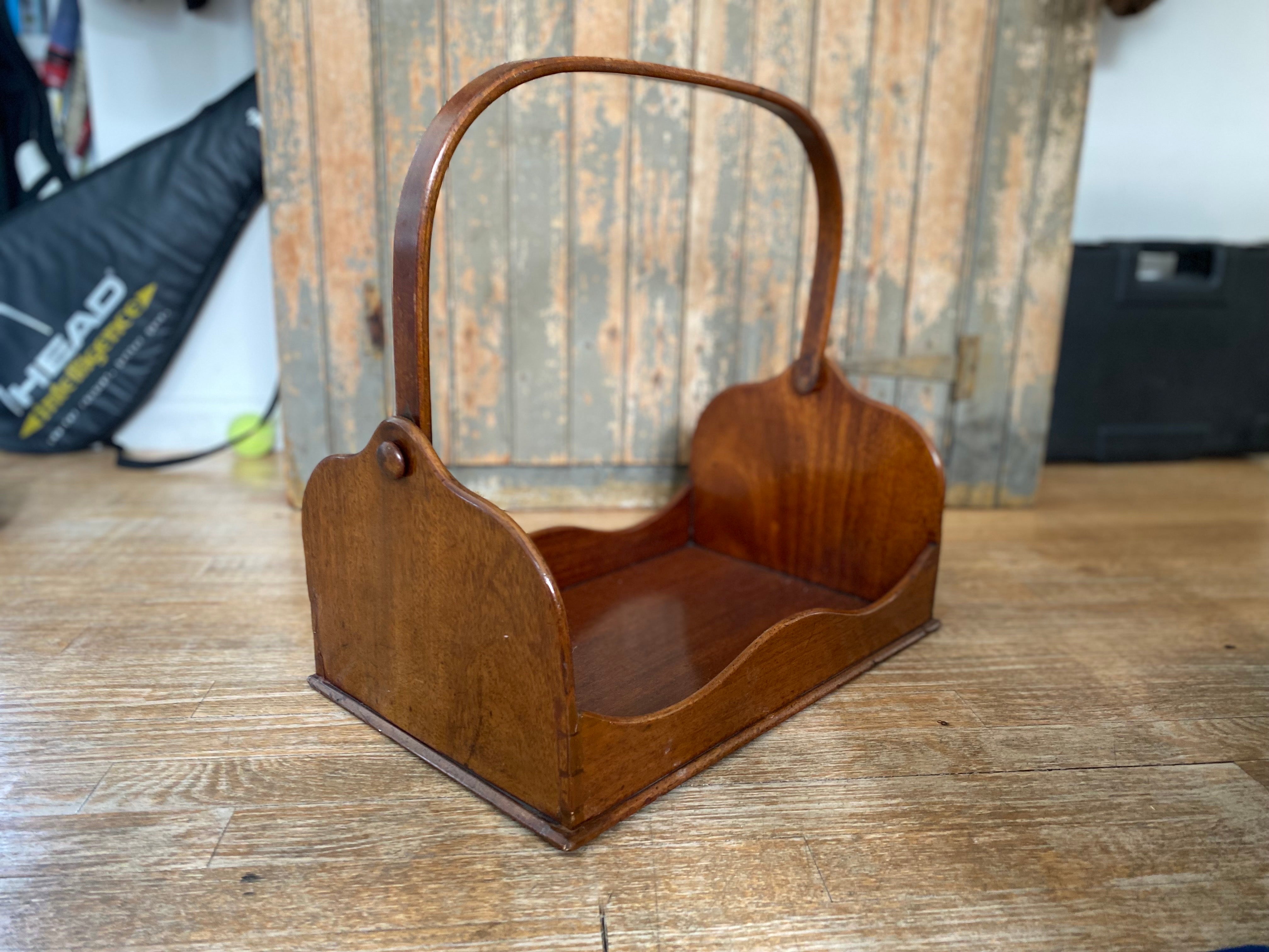 English mahogany book carrier, Late 19th Century

Lovely English book carrier made of mahogany with scalloped shaped side. The handle itself is not in a fixed position and can be moved to either side and has a beautiful inset silver detail on the