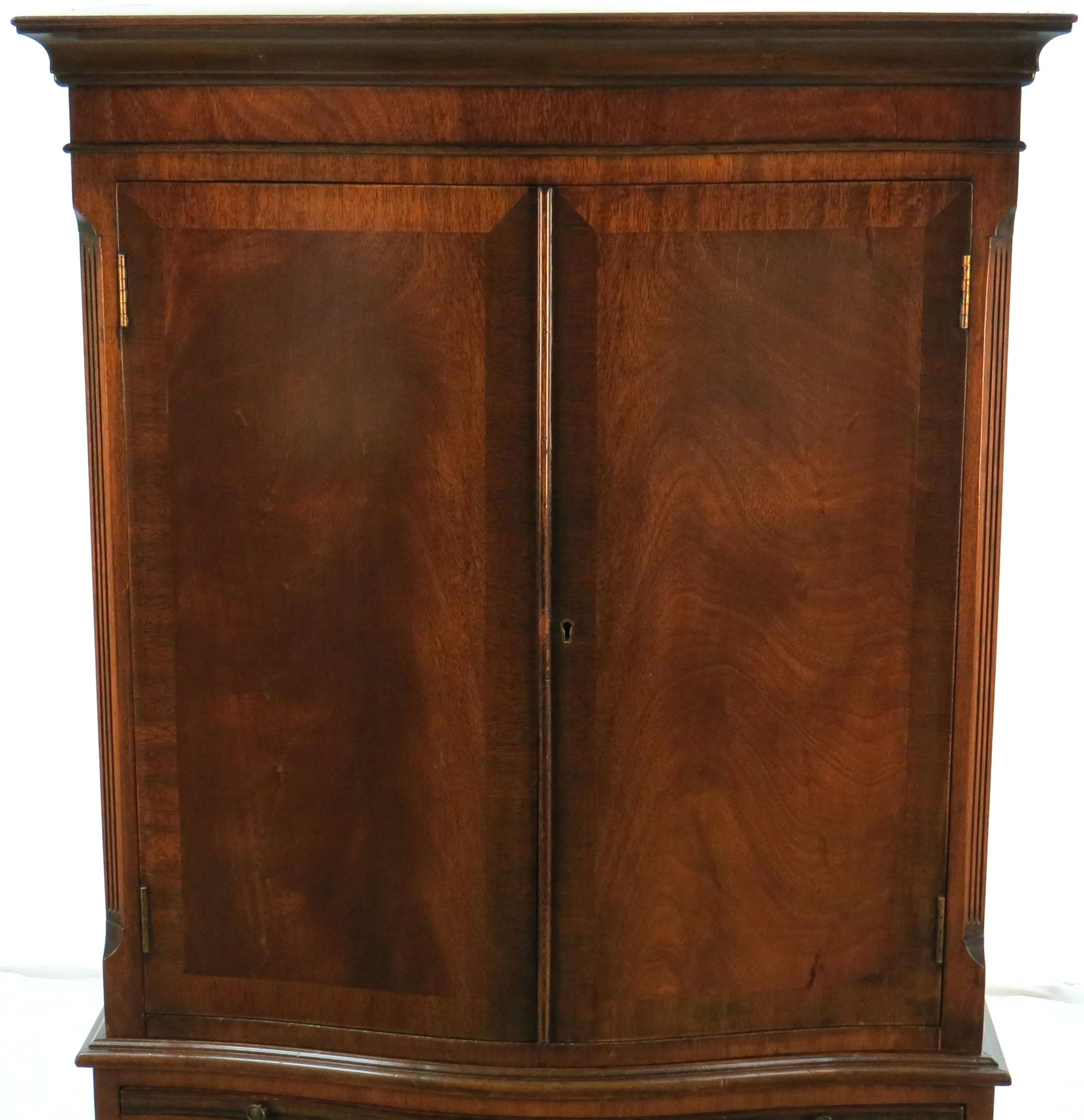 This amazing piece is a two section antique liquor cabinet from England. It was crafted there sometime around the year 1960. From parties to just an evening drink, this bar will serve you and your family in style for many years to come!

The wood