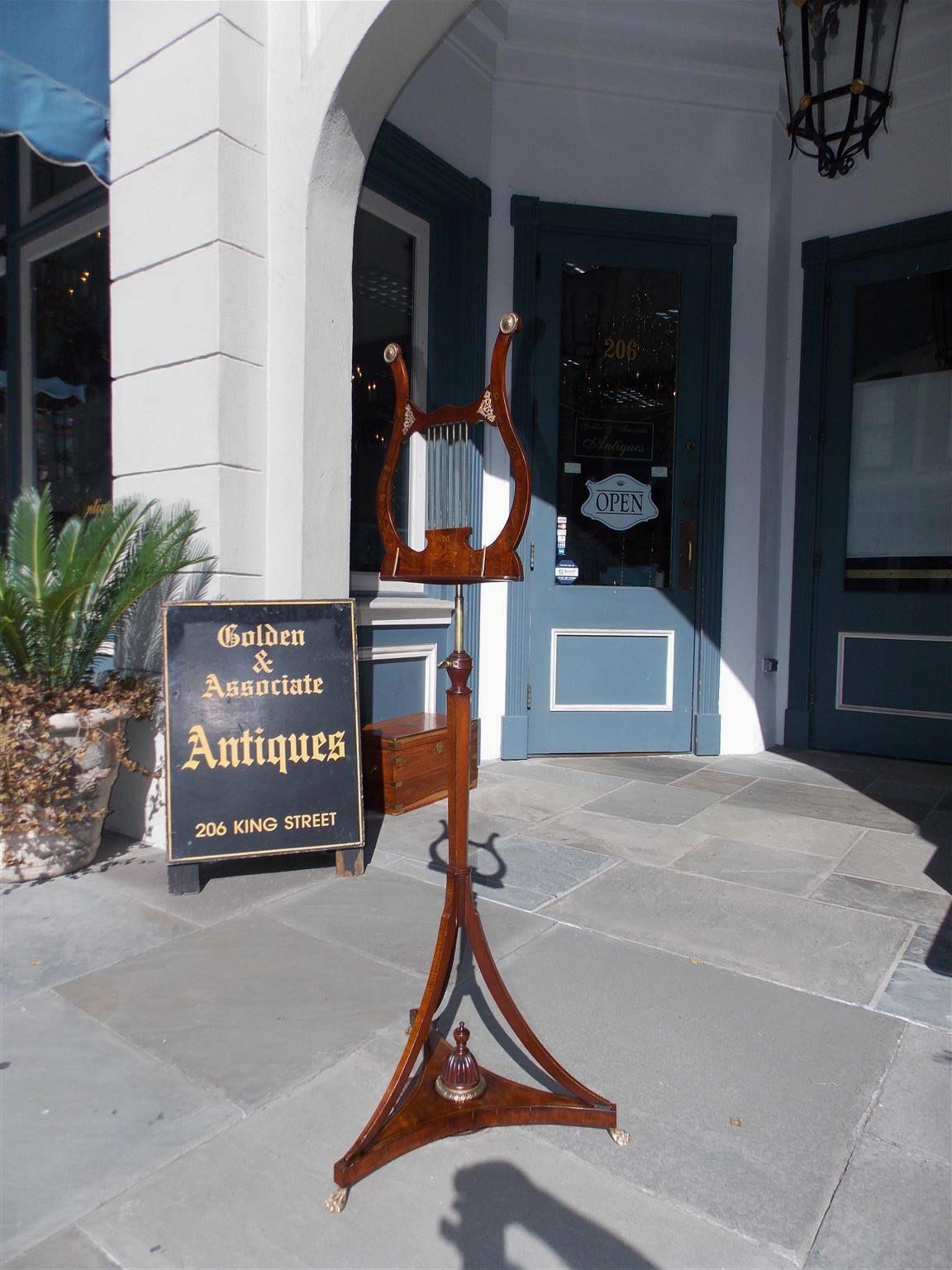 English mahogany bronze mounted lyre music stand with intertwined floral and musical satinwood inlays, adjustable music rest and telescopic brass cylinder, bulbous ringed reverse tapered hexagonal standard, and terminating on out swept tapered legs