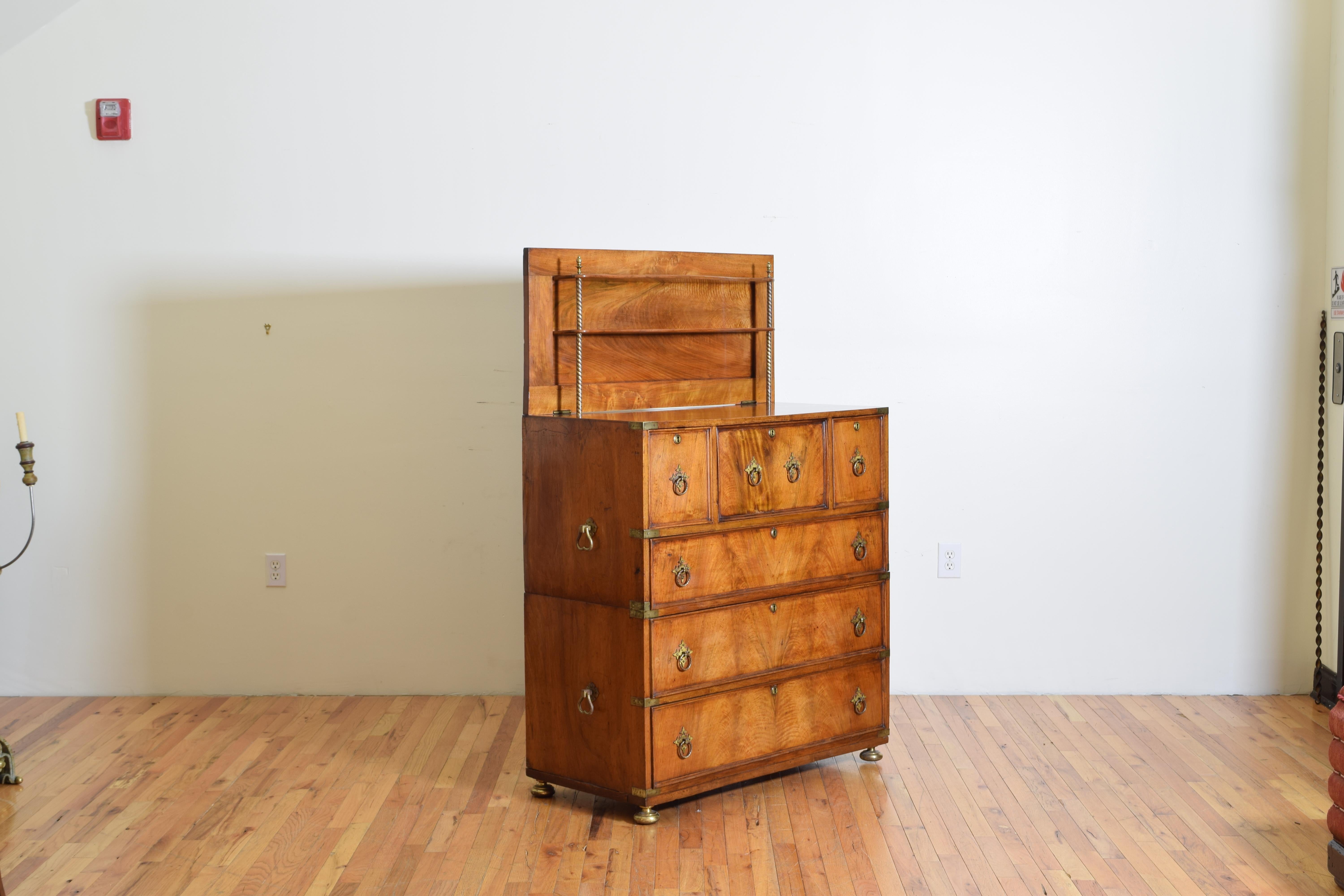 Lower part with two drawers, upper part with large drawer, two small ones and the central one that opens up to form a desk with drawers, compartments and leather top. The floor is raised to form a lift with two shelves supported by removable metal