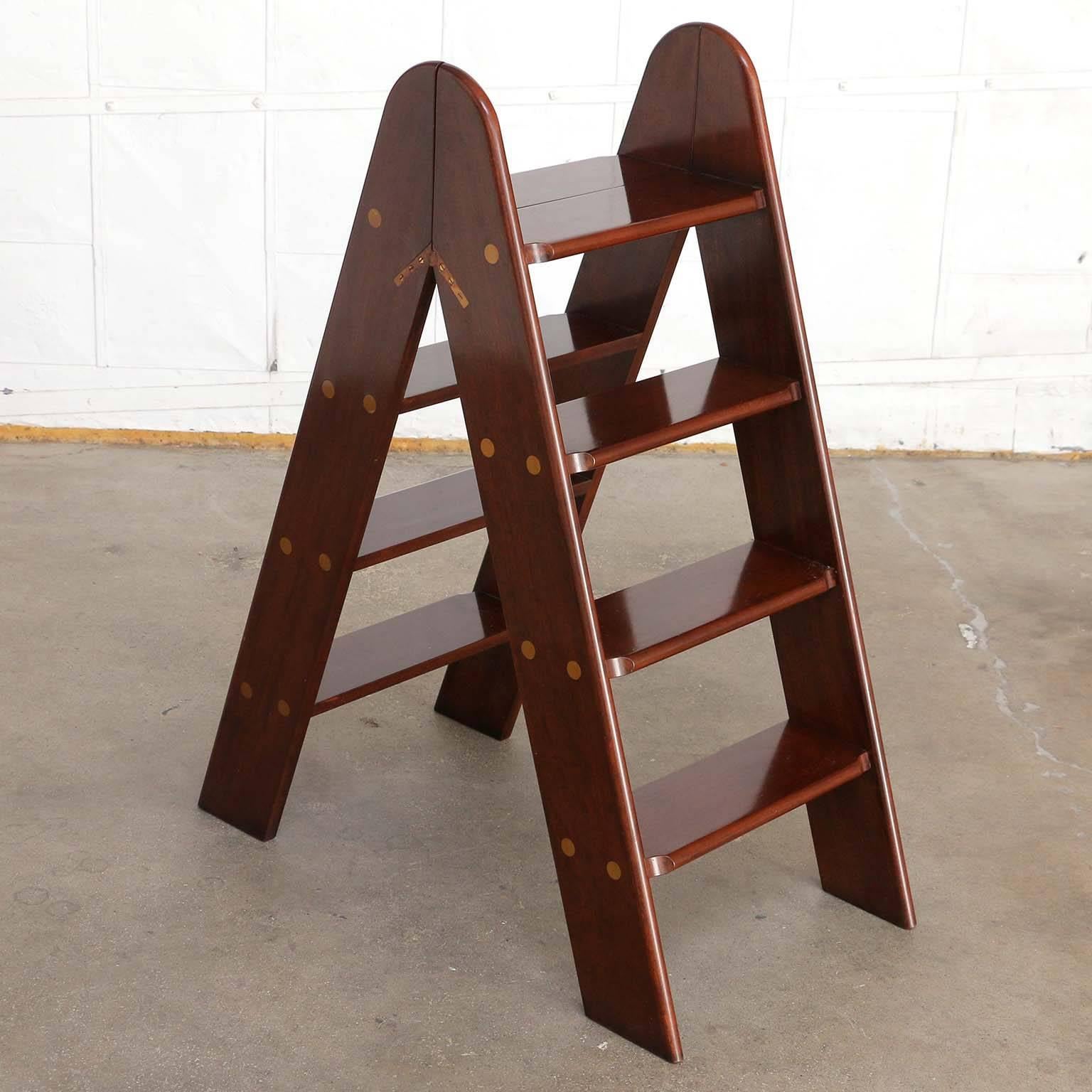 Fine English mahogany library steps or ladder made in the Campaign style. Features four steps on each side with brass mounts and brass flush hardware. Beautifully crafted with a rich mahogany finish. Stamped on bottom.
