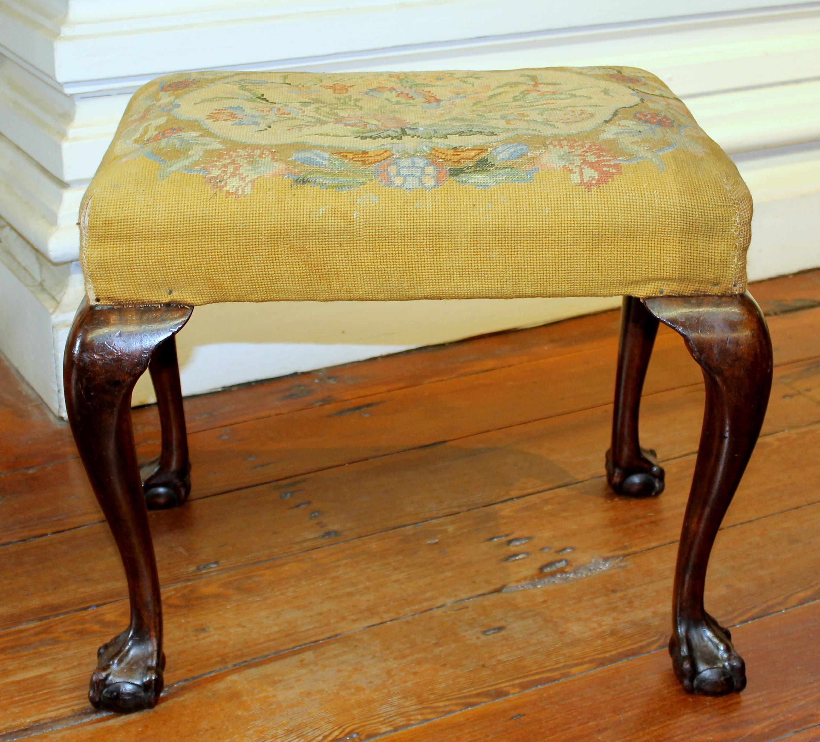 Old English mahogany bench with (possibly original) needlepoint upholstered seat.  

Various slight scratches, bumps and bruises are superficial and can be improved dramatically with some wire wool and wax (which we are happy to perform).