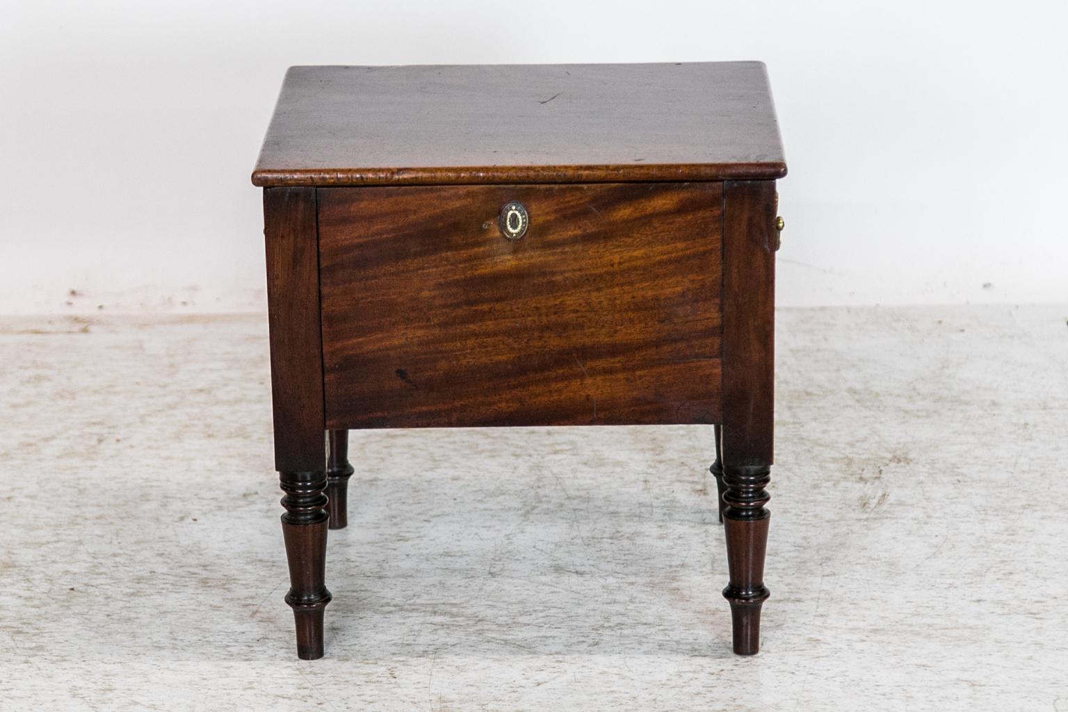 This English mahogany commode does not have its original pottery liner but does have nicely turned legs and carrying handles on each side. 
  