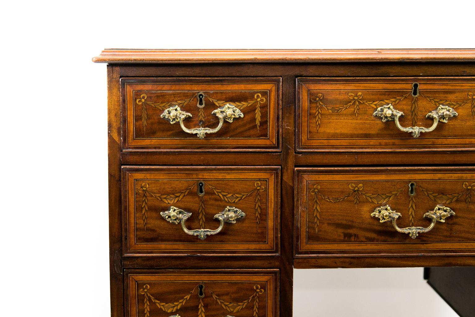 English mahogany eight-drawer inlaid server, the top is crossbanded with satinwood, boxwood, and ebony. The drawers are inlaid with ribbon garlands.
  