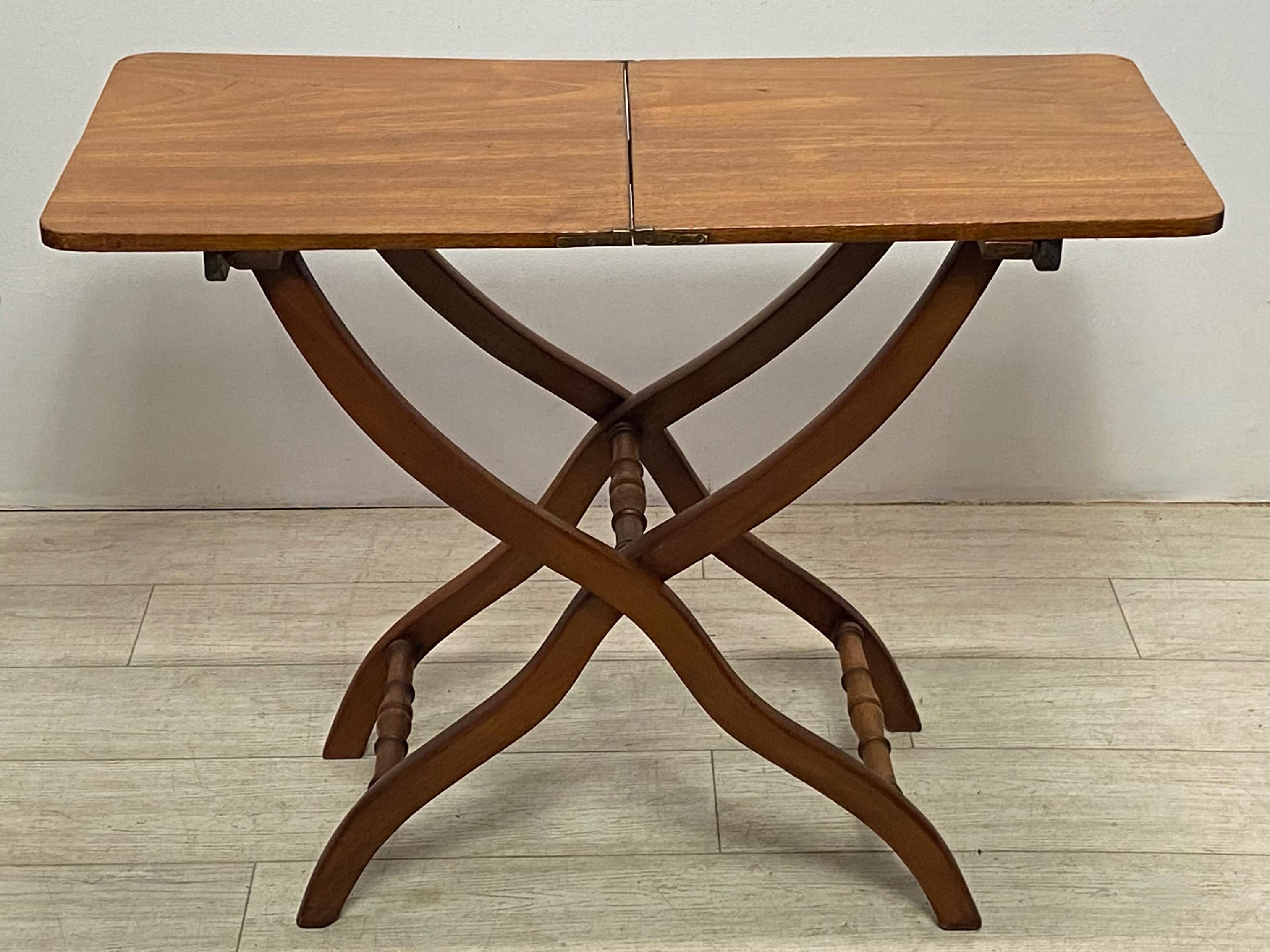 Solid mahogany Campaign style folding table.
England, early to mid 19th century.
Very good original antique condition, having a slight warpage to the top that is fairly common for Campaign tables of this period.


 