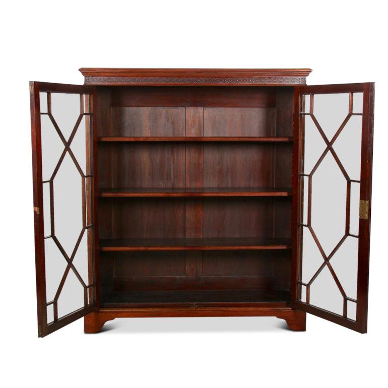 An early 20th century, English Georgian-Revival bookcase in mahogany, with two astragal-glazed doors opening to reveal adjustable shelves, circa 1920.



     