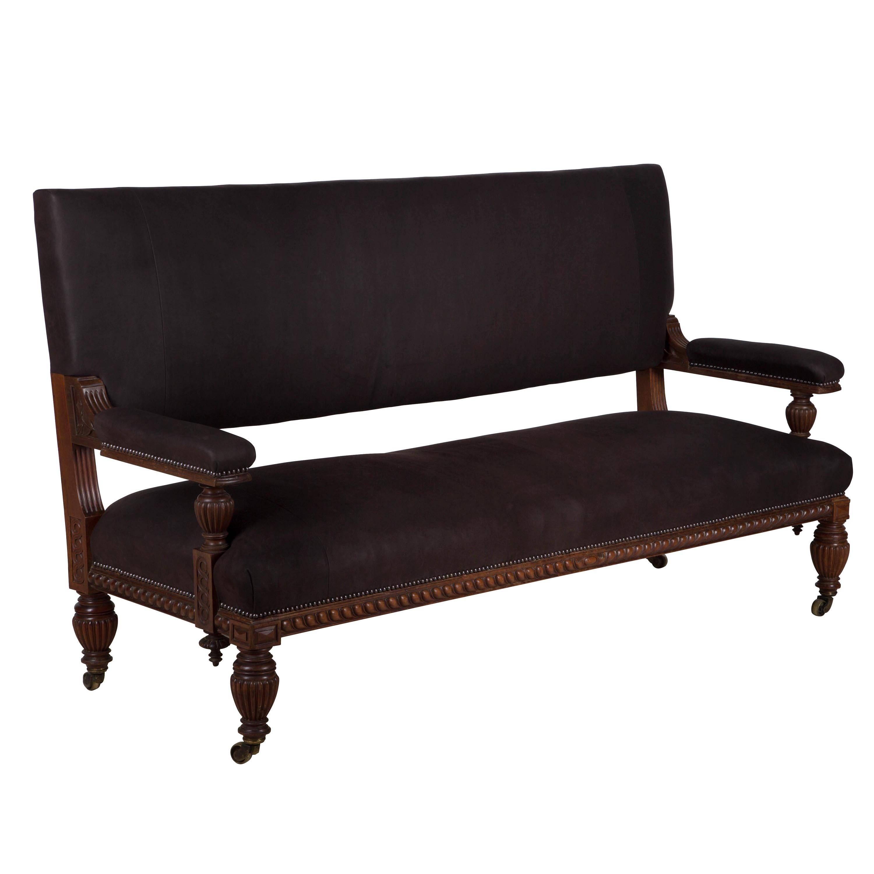 A handsome mid-19th century English carved mahogany hall bench – recovered in a soft and luxurious Argentinean leather.