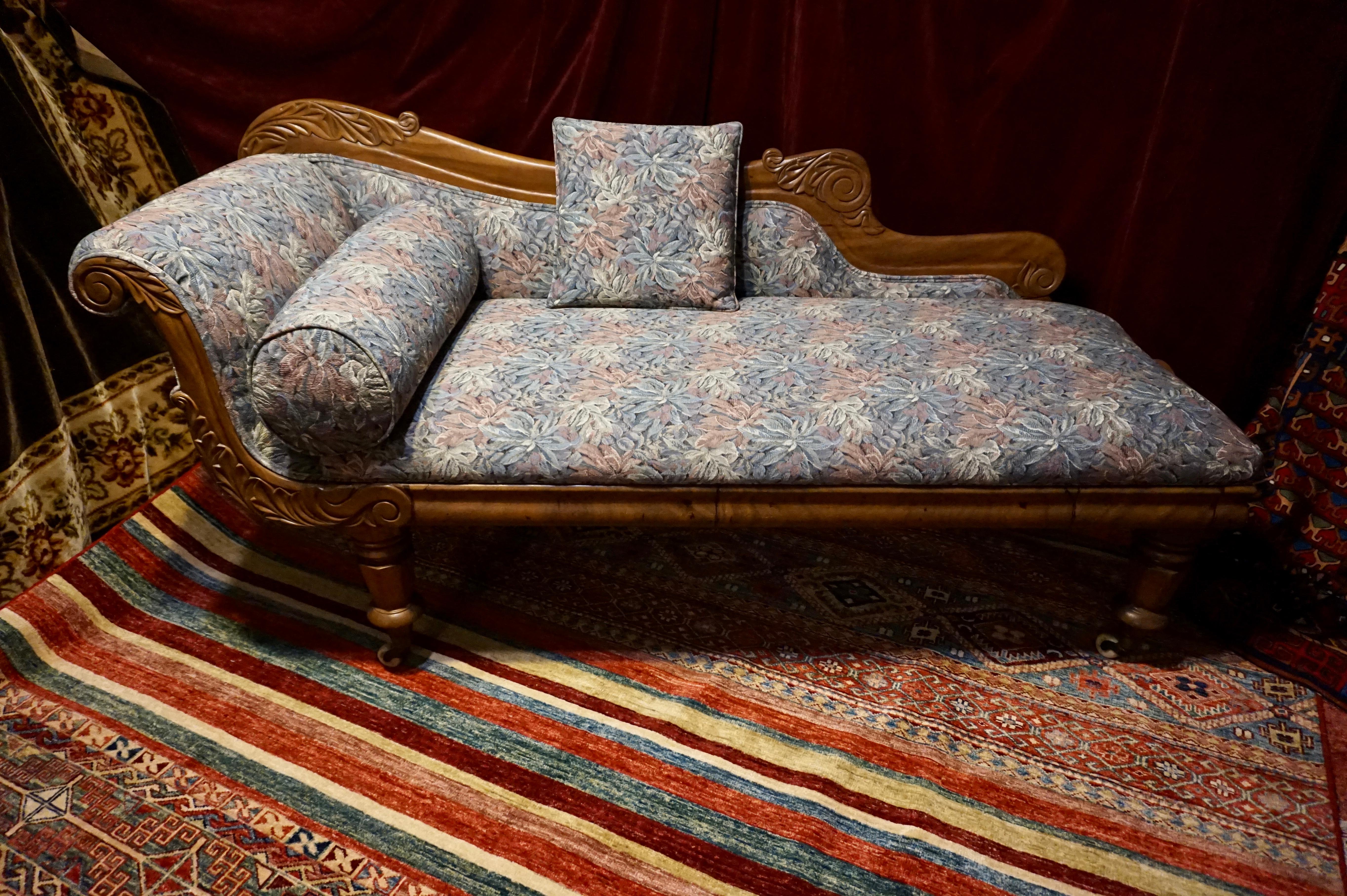 Well proportioned and elegant Victorian chaise lounge in beautiful floral upholstery front to back. Hand carved with finesse and sits on original porcelain casters for ease of movement. A great piece to place by a porch or sunlit bay window and