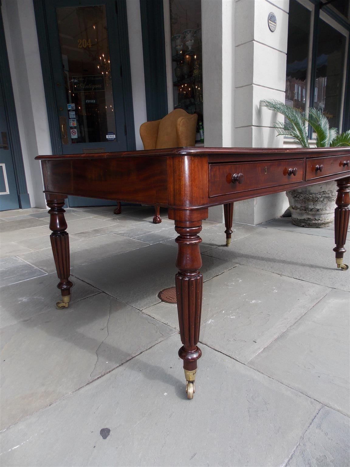 Brass English Mahogany Leather Top Four-Drawer Partners Desk on Casters, Circa 1820
