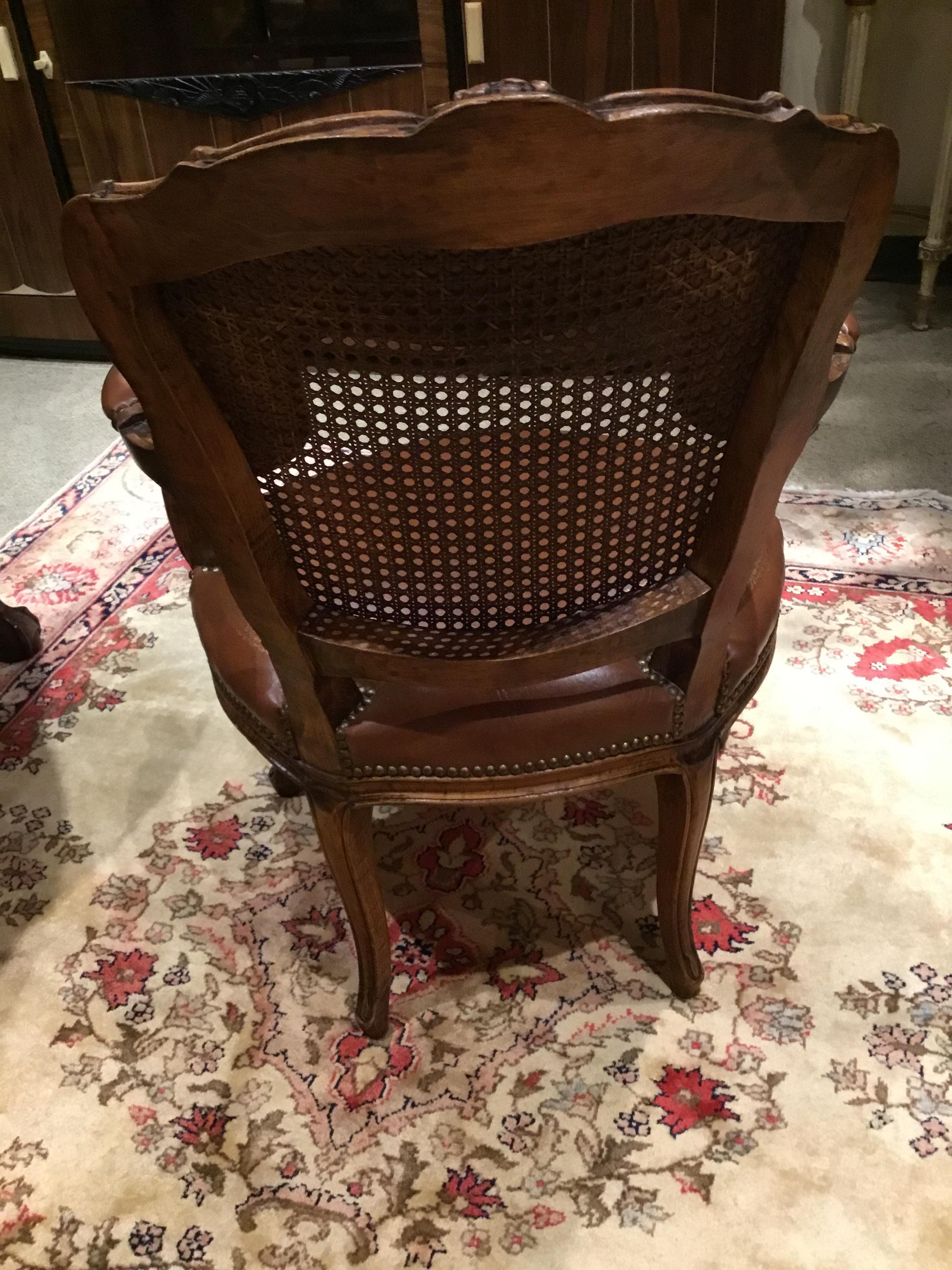 Game table and four chairs that have matching leather. The table has a brown leather with
Gilt trim and an embossed center design. A shell design enhances each of the four legs at
The top and ends in a ball and claw foot. Four chairs with matching