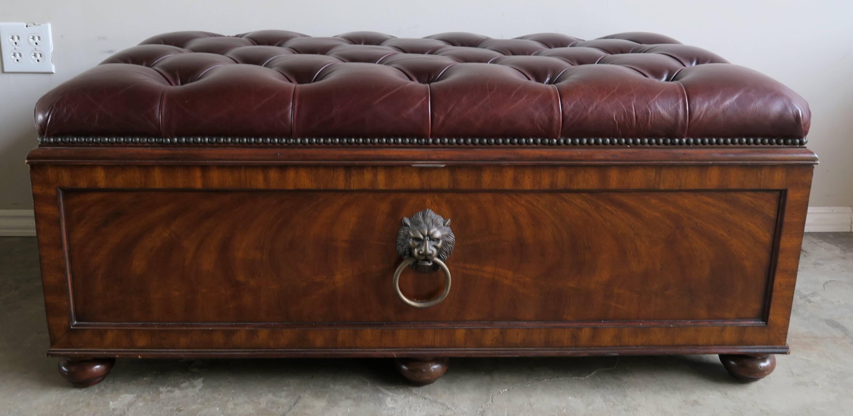English flamed mahogany leather tufted trunk with brass hardware and nailhead trim detail. The chest opens to expose large storage area inside.