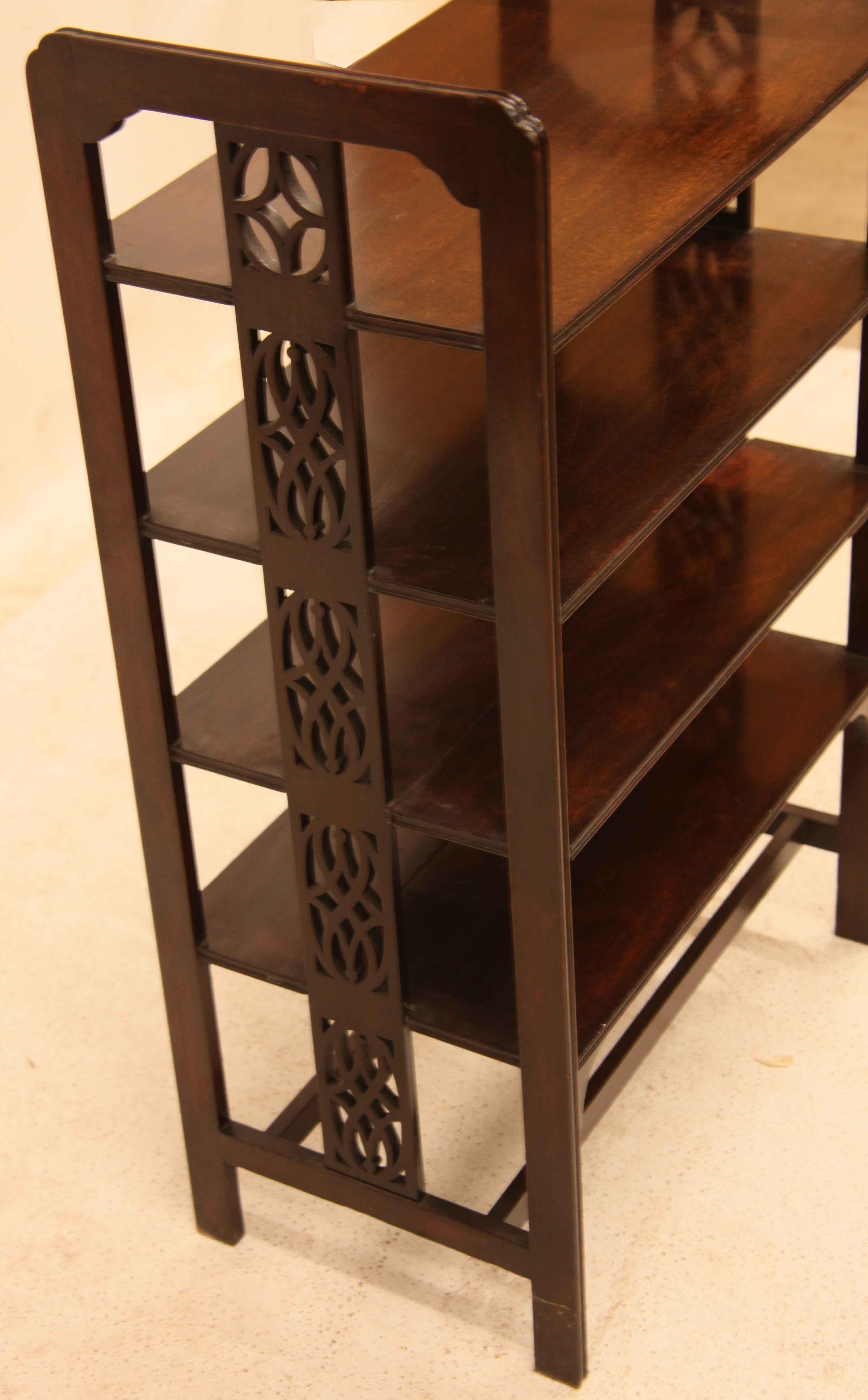English mahogany magazine rack, this piece would be excellent for storing sheet music as well.  It has a rich brown mahogany color and patina.  The outstanding feature is the center of the ends with an open fretwork design that carries the entire