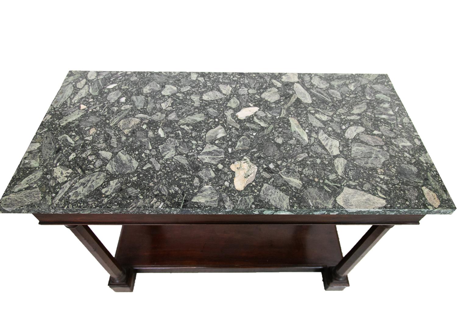 This English mahogany marble-top console table has octagonal shaped legs in the front, and flat legs in the rear with applied architectural pilasters. There are working drawers on the left and right ends. The wooden knobs are original. 
 