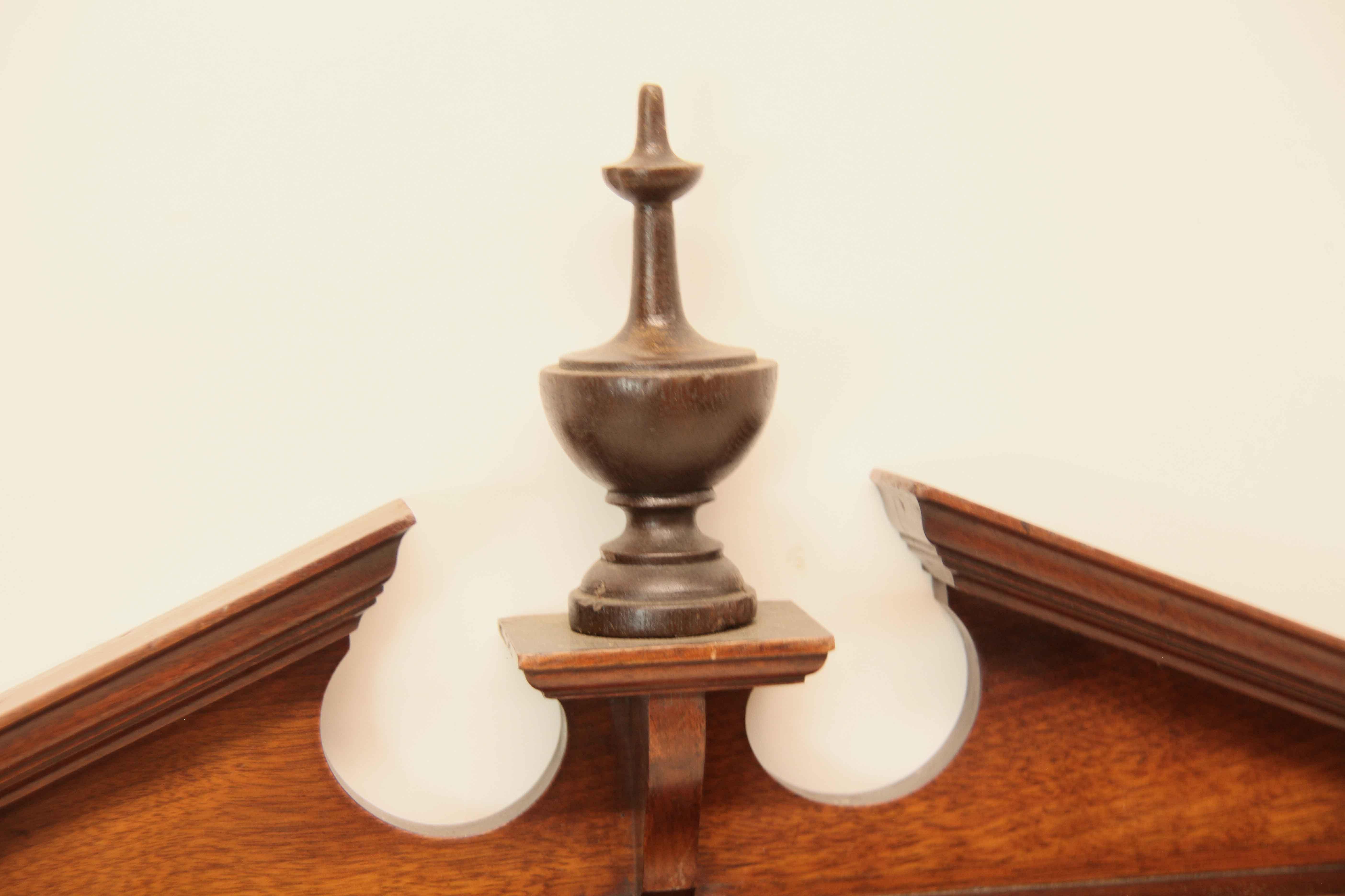 English mahogany mirror, the broken arch pediment with urn finial on plinth, sides have reeded pilasters , bottom of mirror features a one piece series of molding shapes that recede .   
