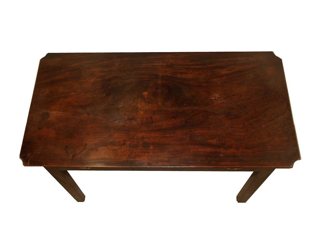 English mahogany one drawer table, the top with figured grain and beautiful patina(minor stains), the corners have a concave shape. The drawer appears to have its original fretwork pulls and escutcheon, oak secondary wood; tapered legs.
