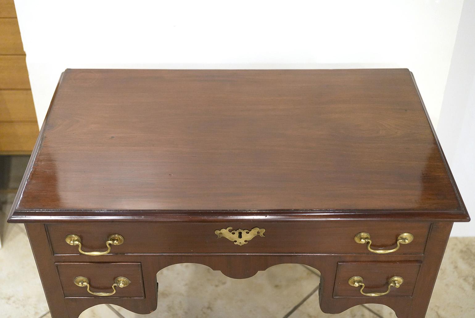 English mahogany Queen Anne lowboy. Molded edge top. Three cock beaded drawers rested on pad feet. Circa 1790s.