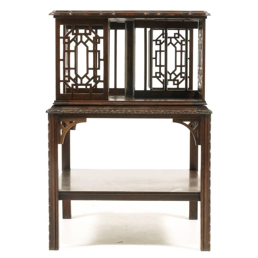 An excellent quality unusually-small English Edwardian solid mahogany revolving bookcase having four sections for books, each side in an elegant pierced ‘Chinese Chippendale’ style.
         