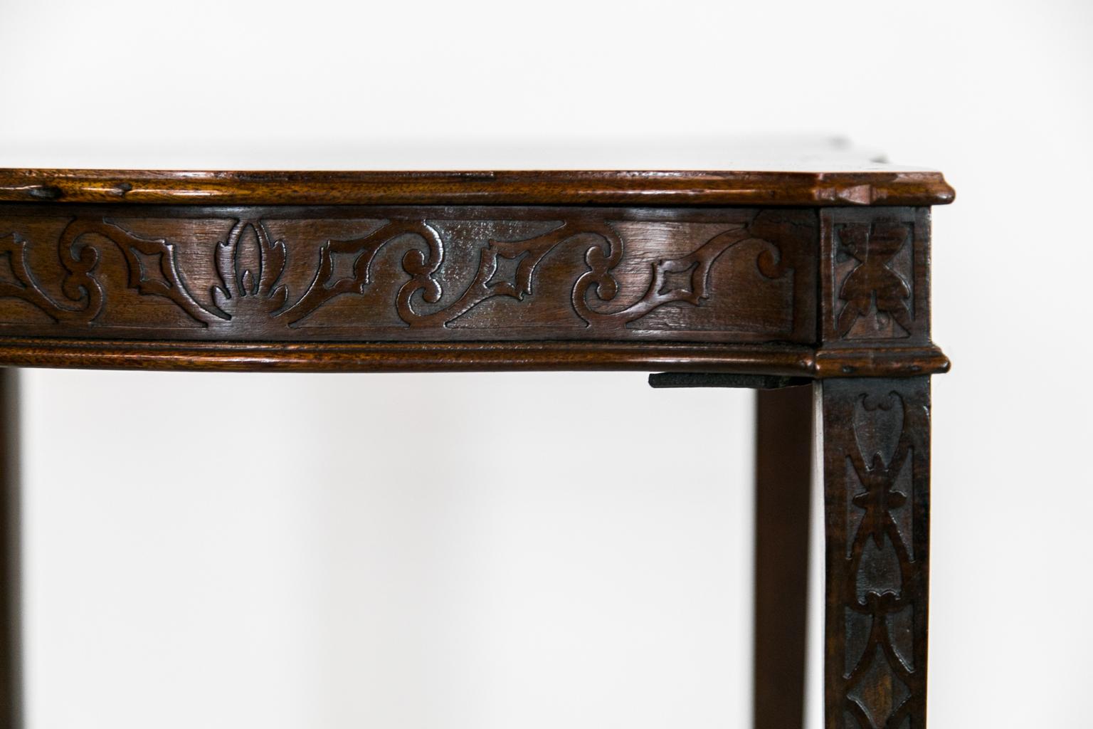 This serpentine table has a blind fretwork apron and legs with an 