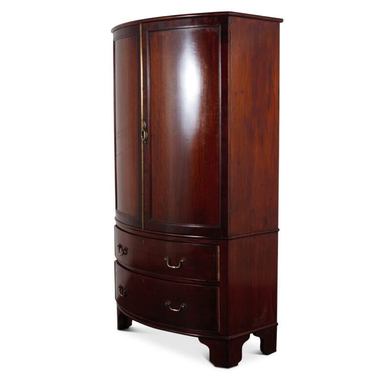 English mahogany, late-Victorian, sheraton revival bow front linen press with fitted pull-out trays in the top and a pair of large drawers below. This is an unusual size on the smaller scale and has a bow front.