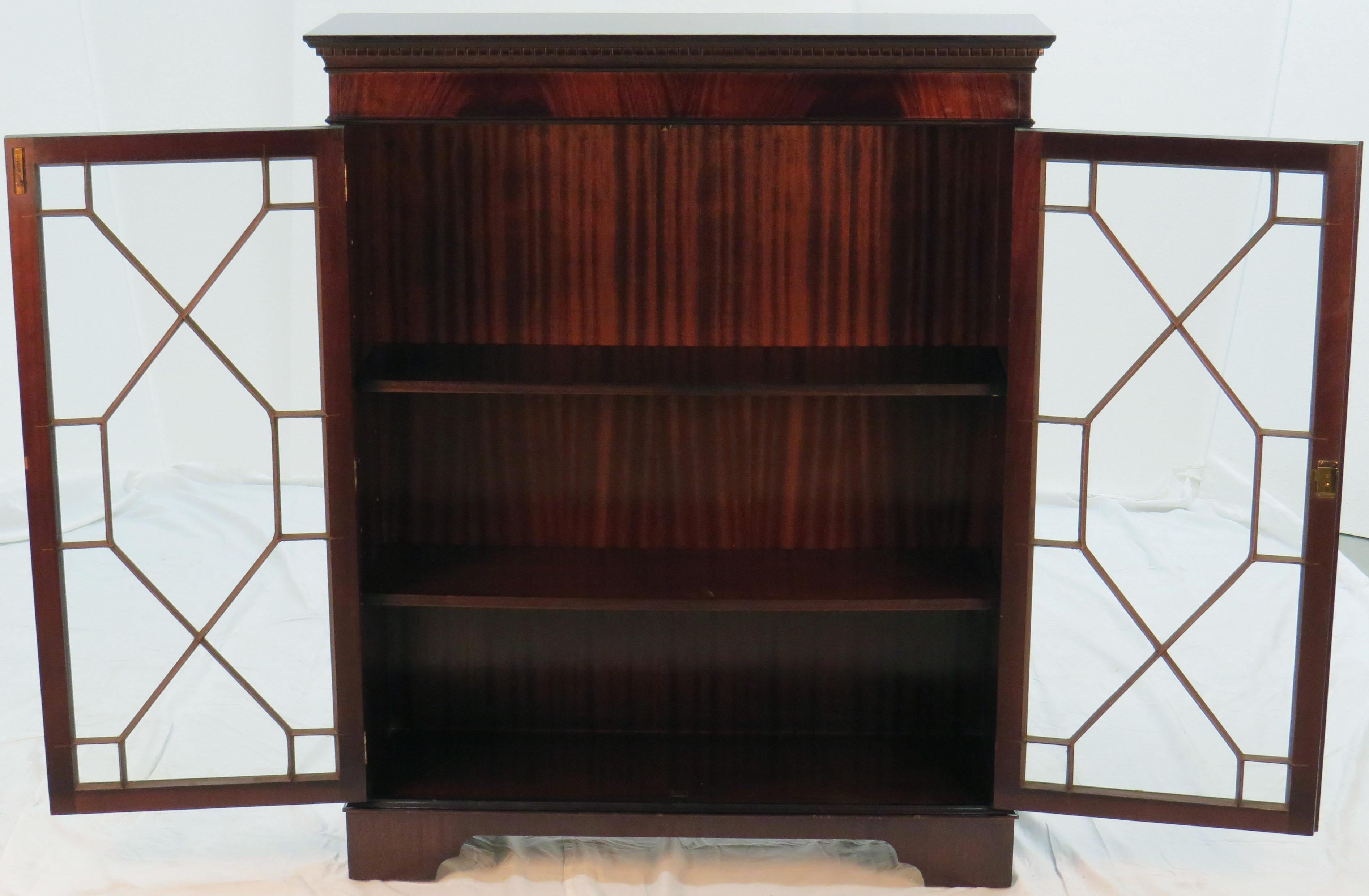You will not find a finer piece of furniture for displaying just about anything! This antique English mahogany bookcase with glass doors is a stunning piece in good condition that is sure to remain an integral part of your furniture collection for