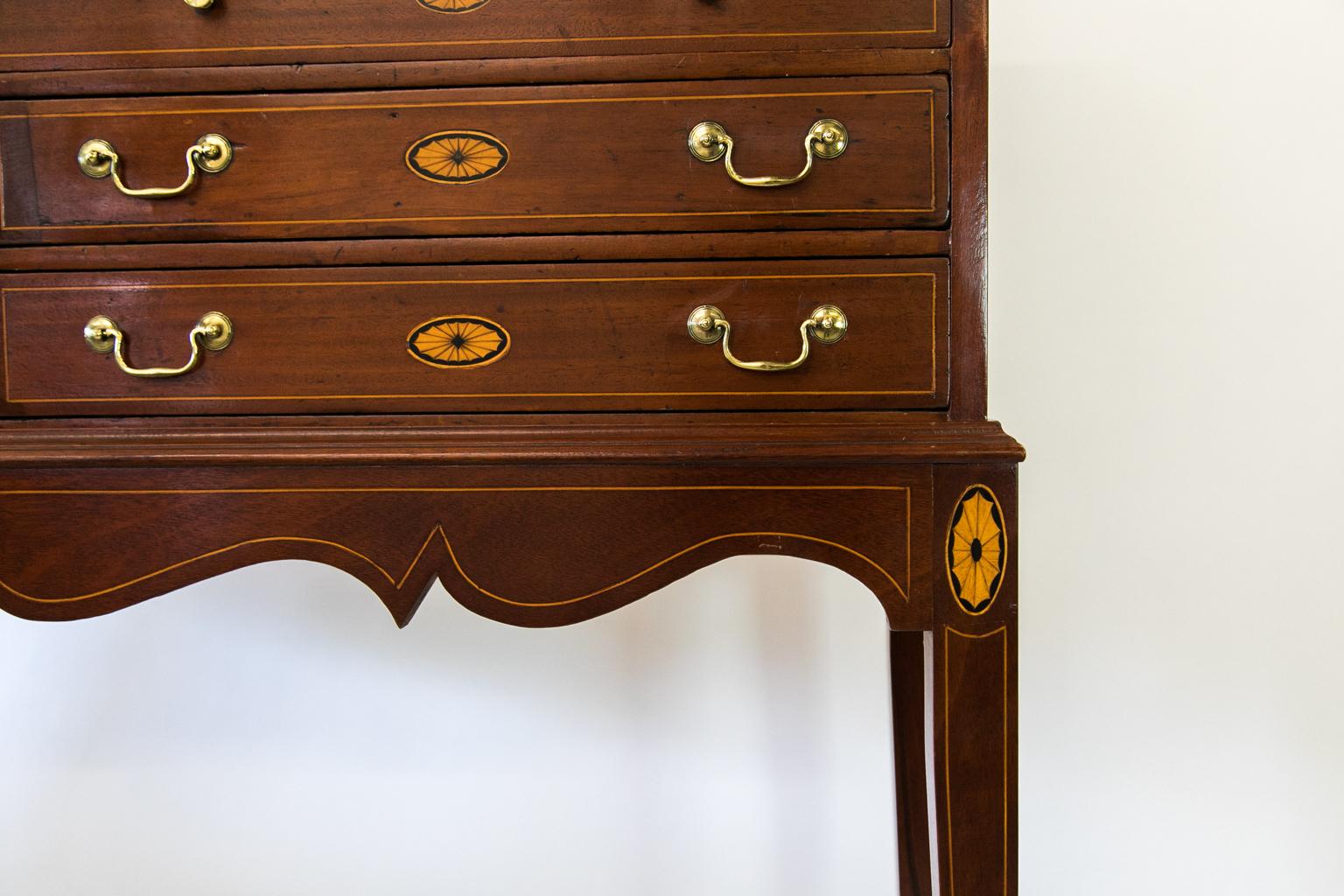English mahogany sixteen-drawer chest, rests on a custom made base. The graduated drawers are inlaid with boxwood and oval medallions. It has been refinished, and the inlay and hardware were added later.
