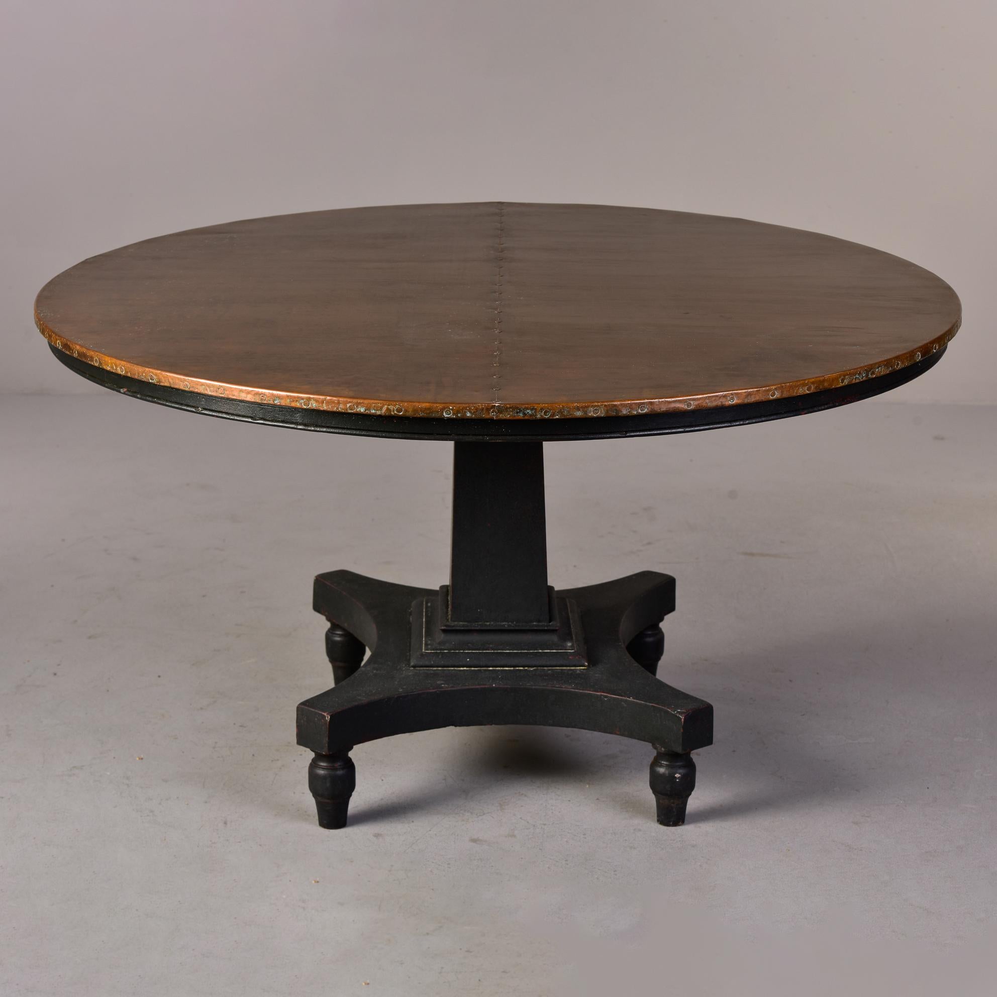 Circa 1900 English round mahogany table has a painted black base with new copper top. Unknown maker. 

Base Only: 28.5” H x 27.5” W x 23.5” D.