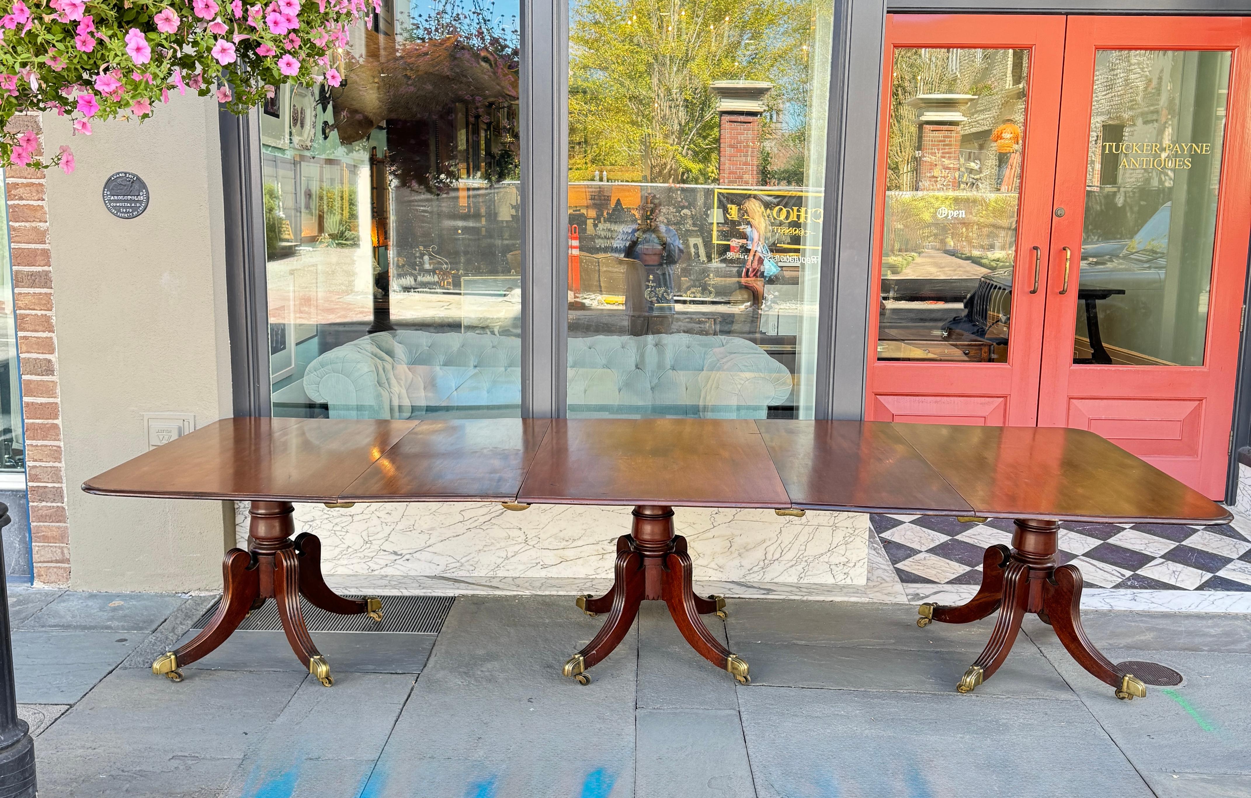 English mahogany three pedestal dining room table with two leaves 92 inches without the leaves 132 overall with three tops tilt on pedestal base