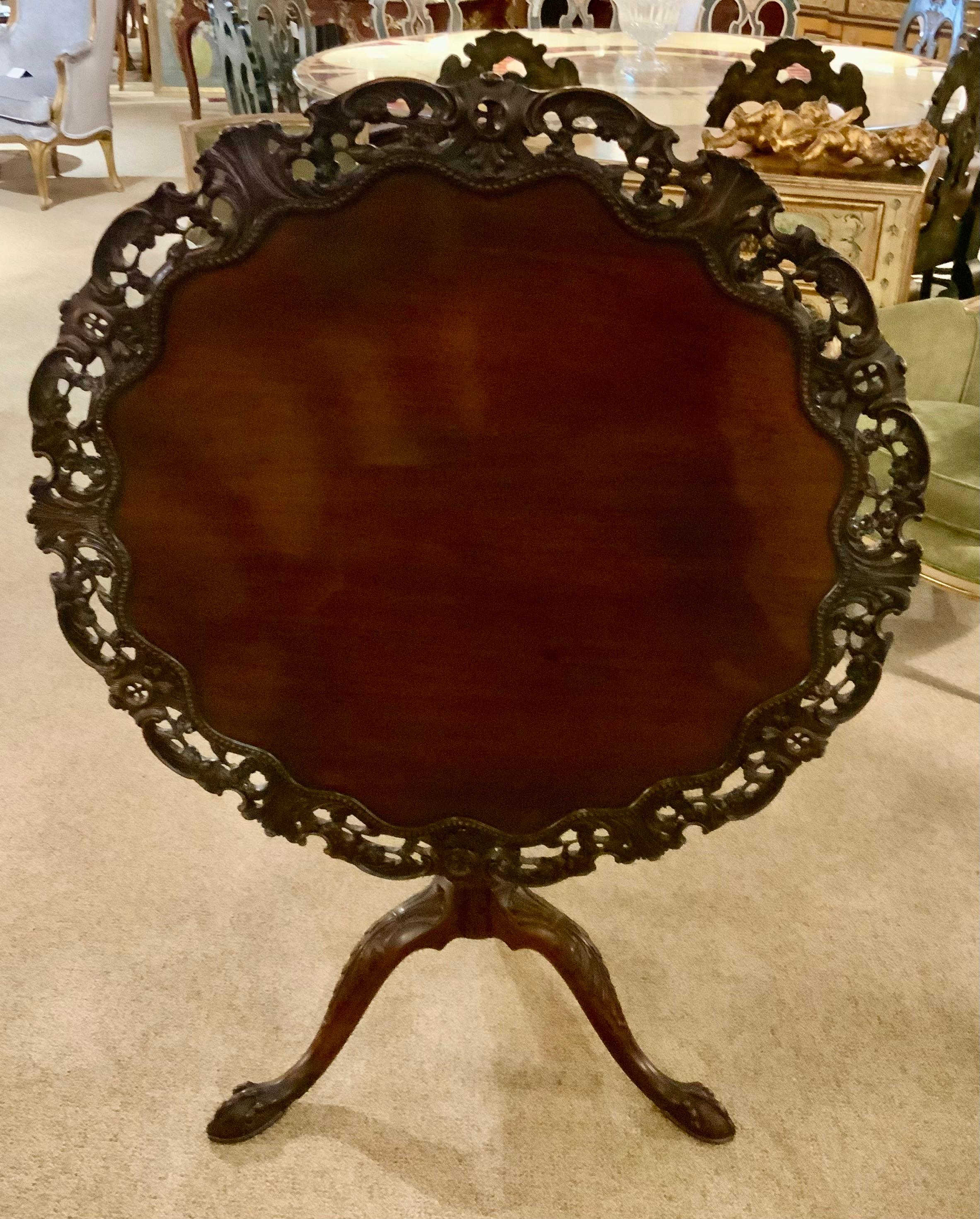 The exceptional carving and quality wood used in this piece
Make it special. It has a tilt top movement that works easily
The top has been French polished and is without
Scratches. The carved edge was done by a master
Craftsman.