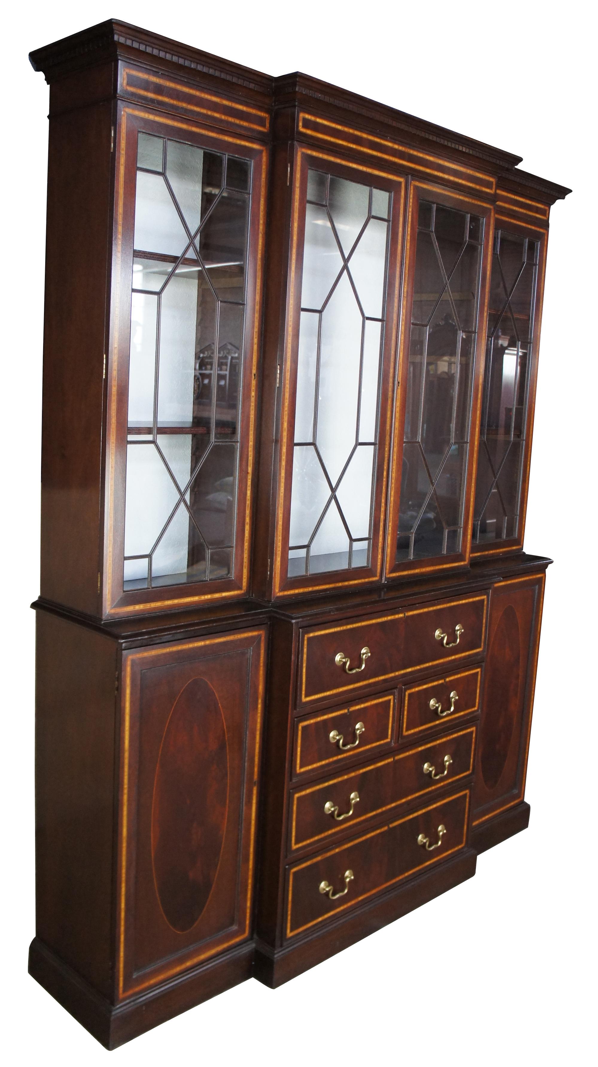 English mahogany & walnut breakfront bookcase secretary Chippendale Georgian

Custom made English breakfront. Made from mahogany with banding and walnut burled lower doors. The bookcase features fretwork over the glass doors with the interior