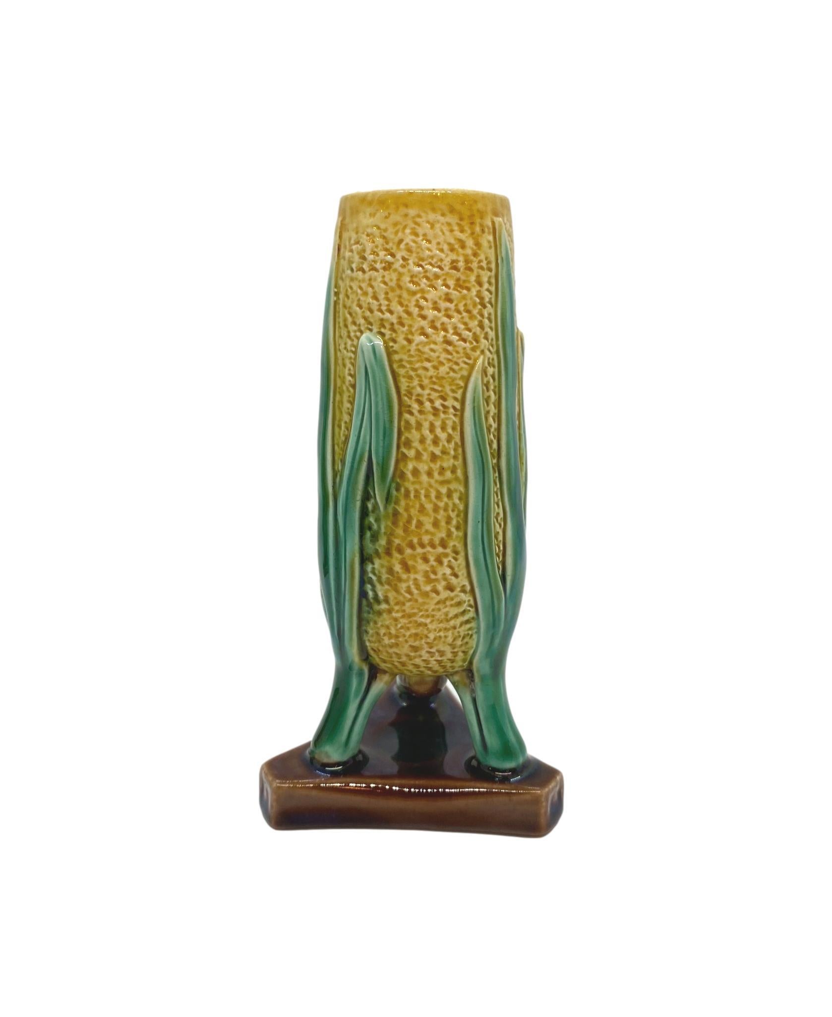 English Majolica 5-in Vase/Posy Holder, of amphora form on tripod with pedestal base, molded as yellow glazed ear of corn with green shucks, the interior glazed in pink, ca. 1875 
For 30 years we have been among the world's preeminent specialists
