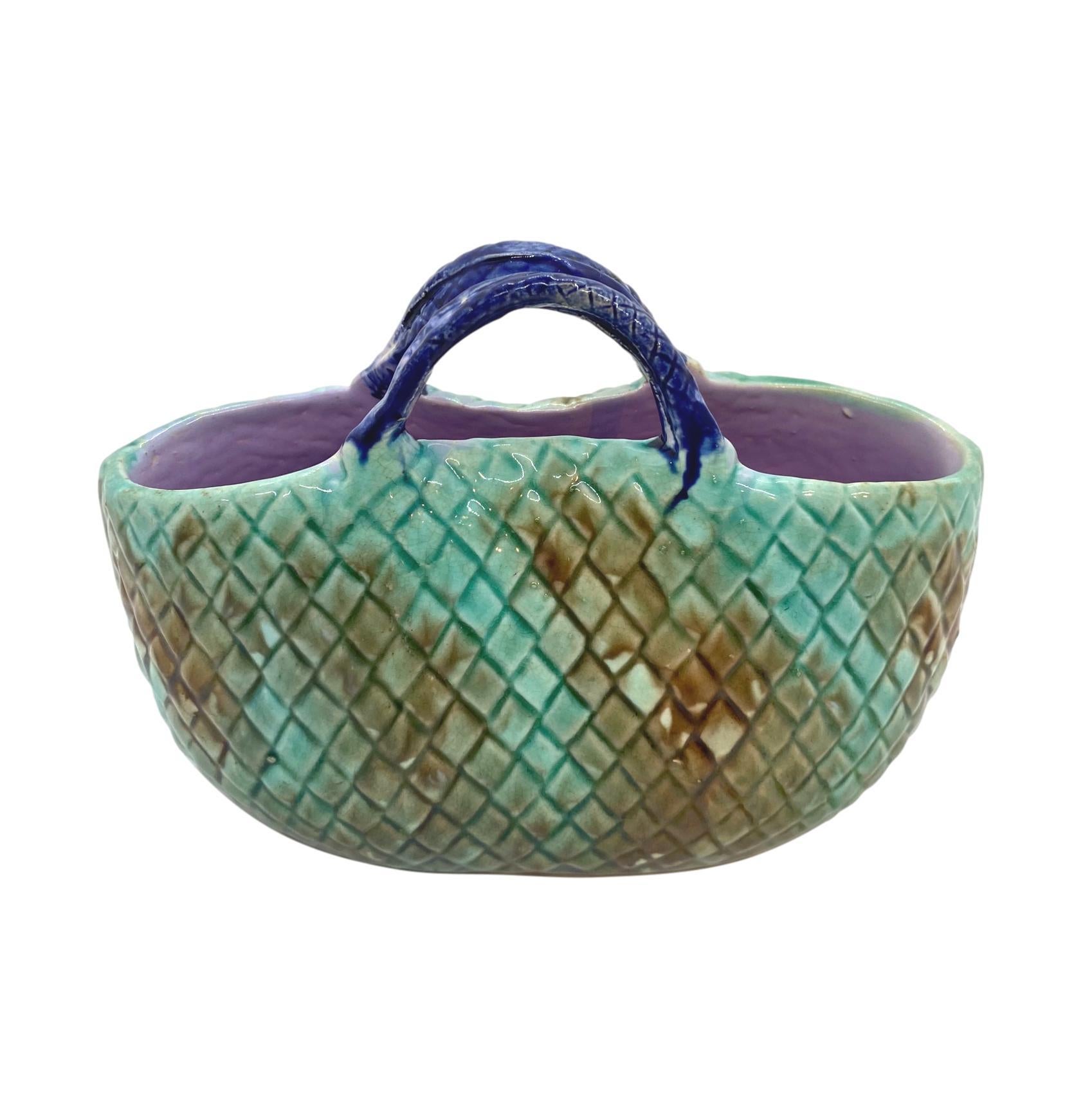 English Majolica basket with mottled green basketweave, a cobalt blue handle, and lavender interior, ca. 1875,
Measures: W 6 x H 4 x D 1.5 inches
For 30 years we have been among the world's preeminent specialists in fine antique majolica.