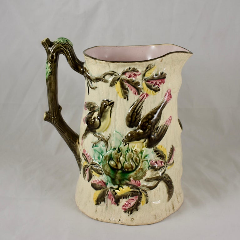 An early, English Majolica birds nest pitcher, maker unknown, circa 1875.

A wonderful example of a desirable mold in unusual bright Majolica glazing. Showing a design of a mother and father bird feeding a nest of babies. The nest rests in a leafy